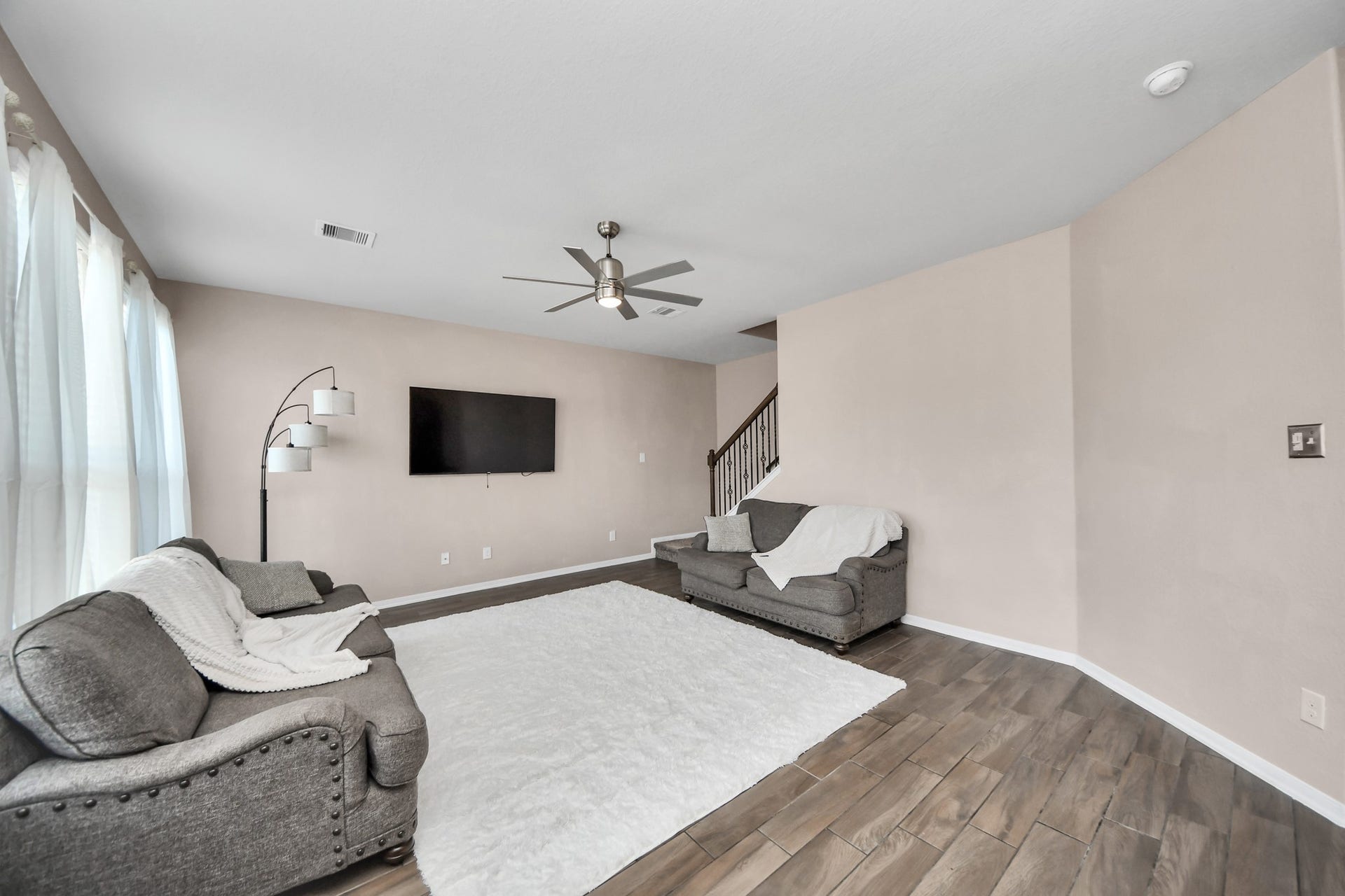 Spacious, light-filled living room with soaring ceilings offers the perfect setting to relax, entertain and make lasting memories.