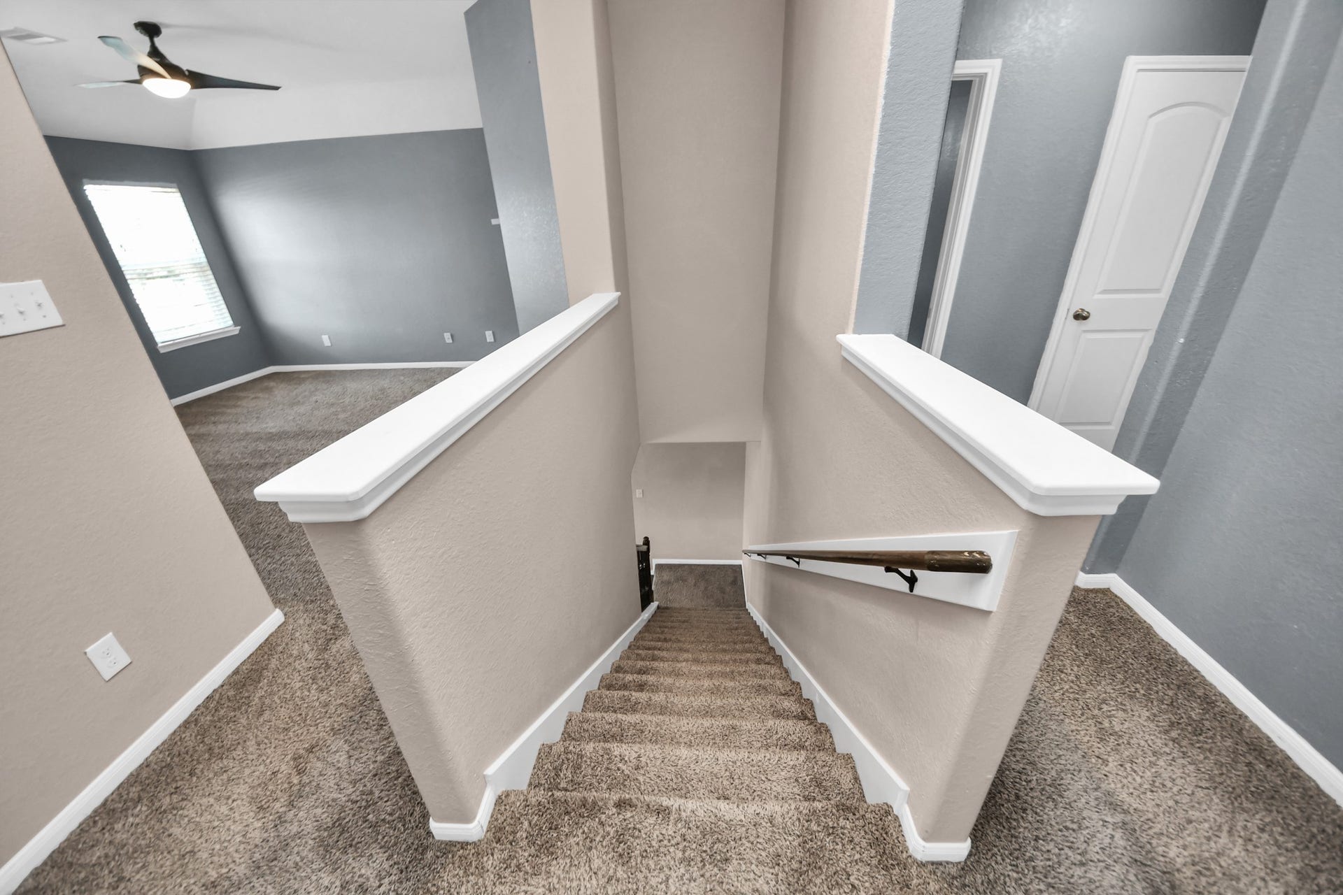 The second floor features a flex/game room to the left, two secondary bedrooms and a full bathroom down the right hallway, plus the primary suite and laundry room located behind this view.