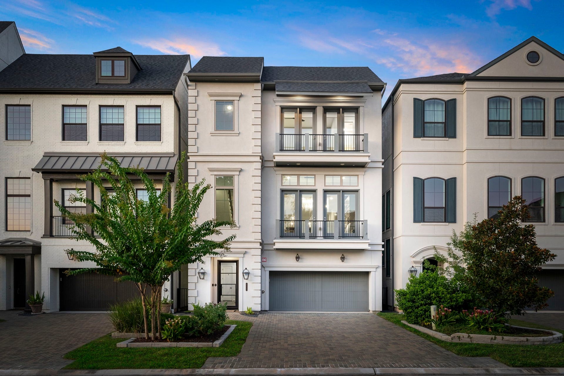 Beneath a sunset sky, this stately single family lakefront residence makes a striking first impression double balconies facing the front motorcourt and the back facing Lake Wodlands.