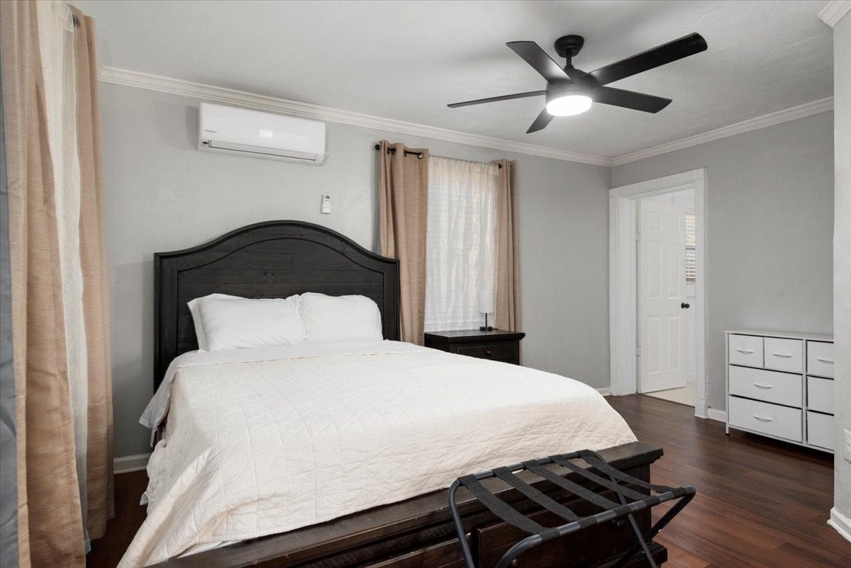 215 Caplin Street, Houston, TX 77022 Spacious secondary bedroom with ceiling fan and natural light.