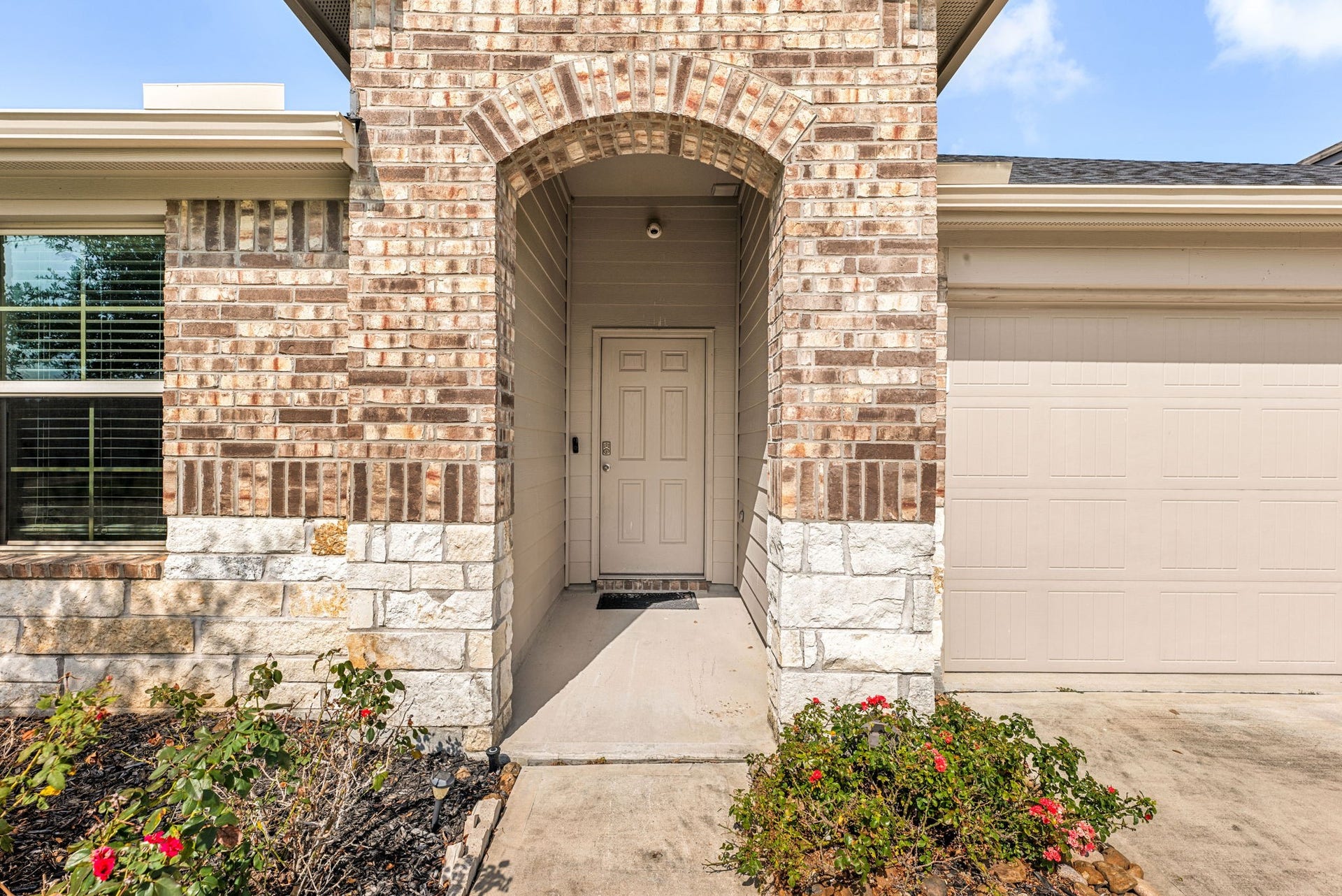Charming stone-accented entry creates a welcoming first impression.