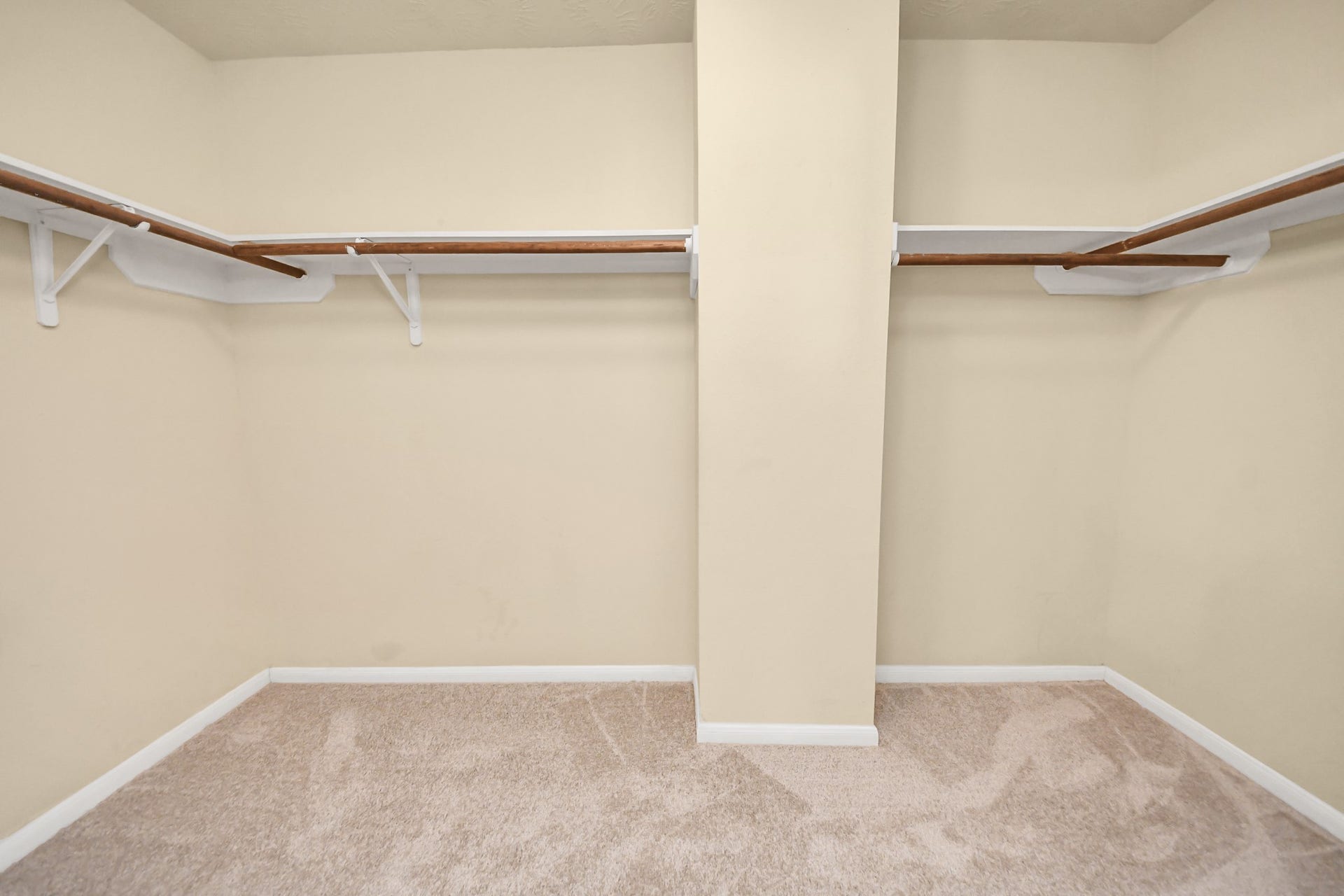 Walk-in closet with ample shelving and hanging space, perfect for organizing your wardrobe.