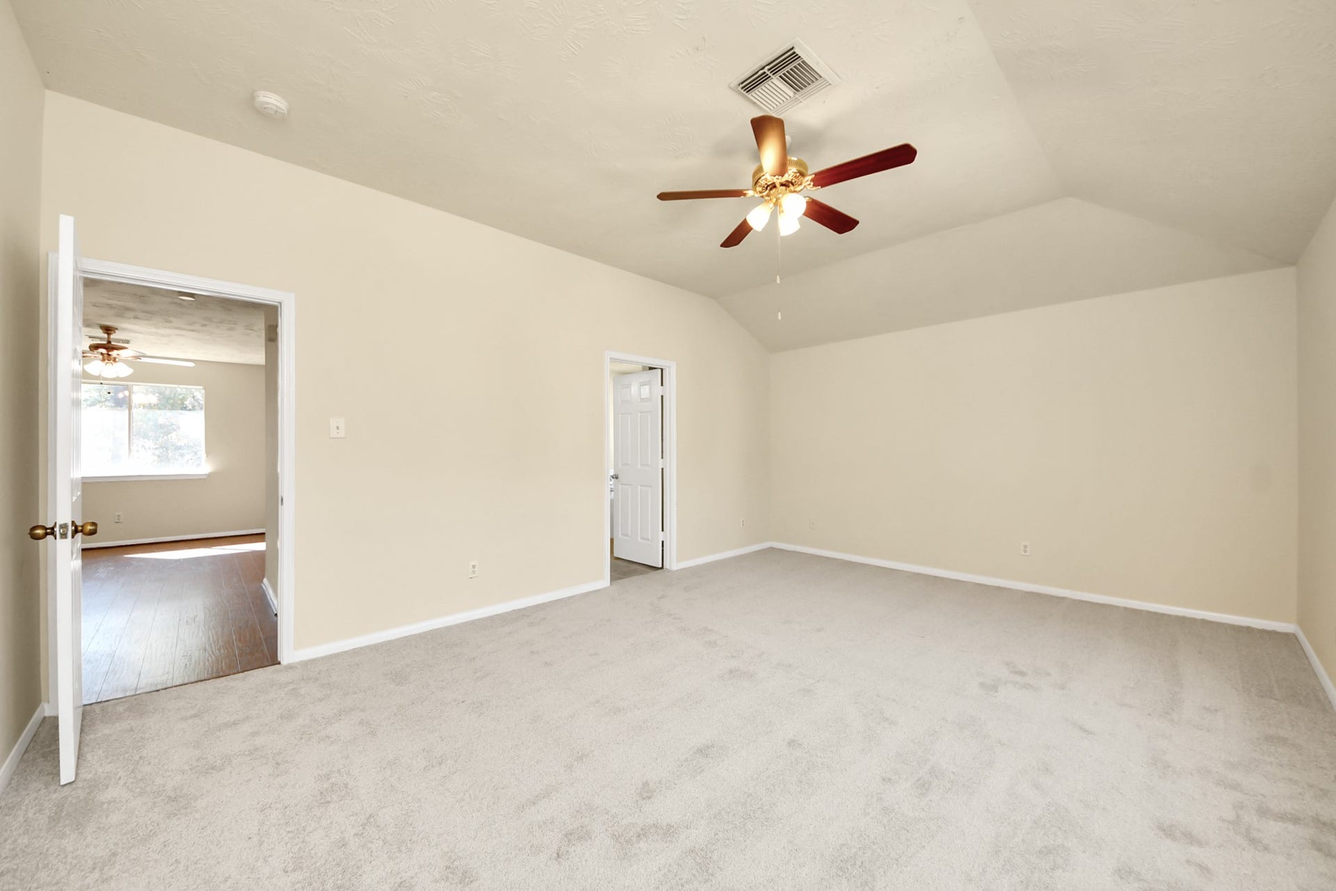 Large primary with new paint and carpet, ceiling fan, and lots of natural light.