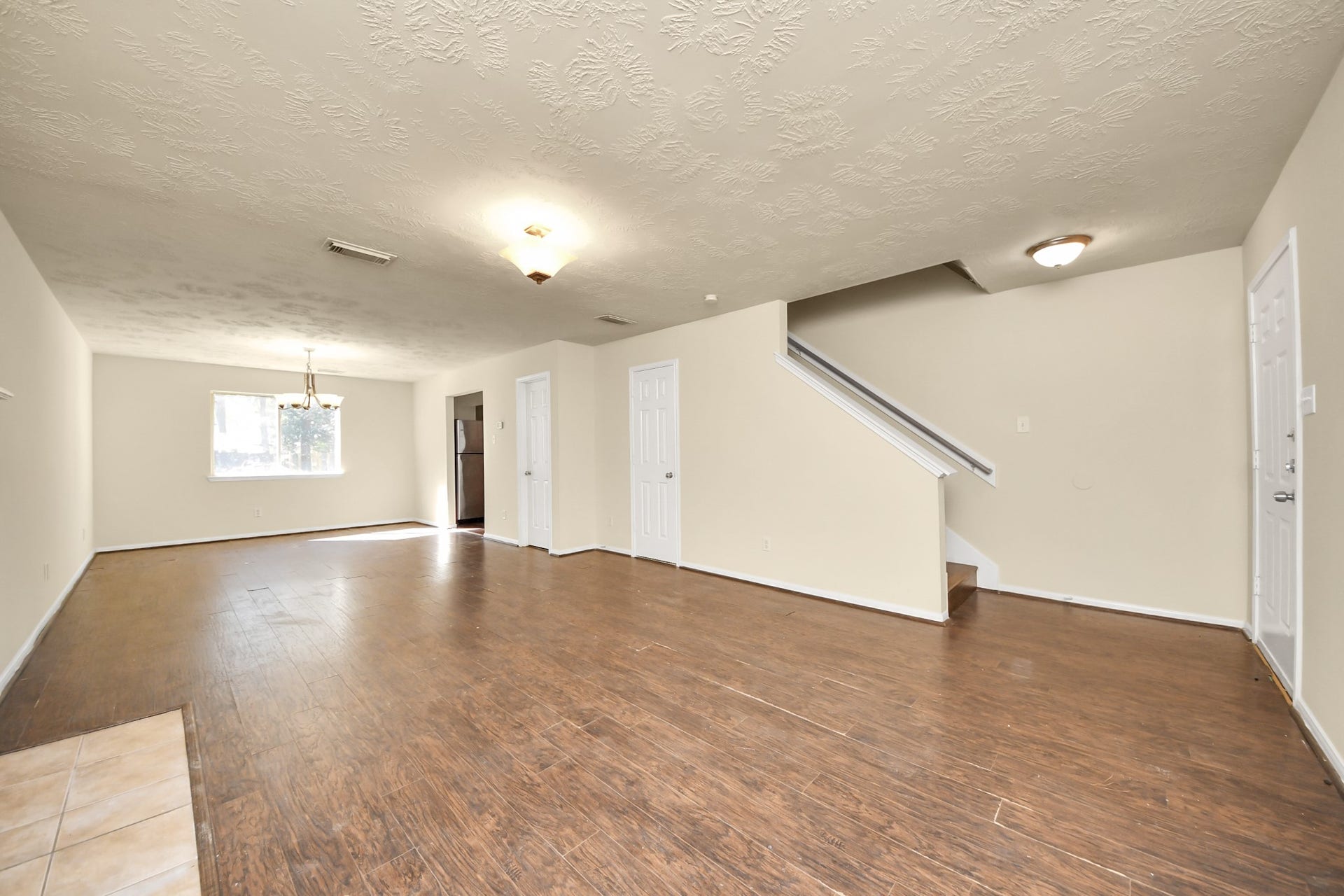 Large living and dining space complete with half bathroom and fireplace.