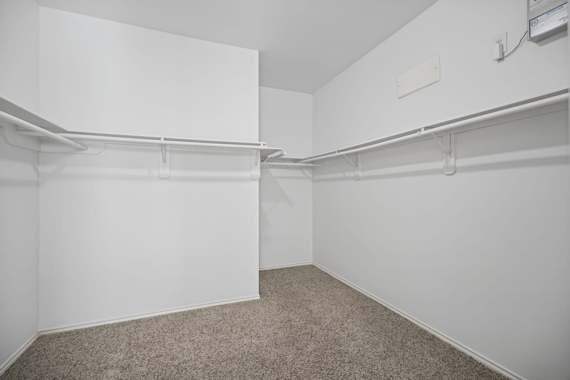 The walk-in closet completes this portion of the suite with shelving and hanging space arranged along multiple walls.