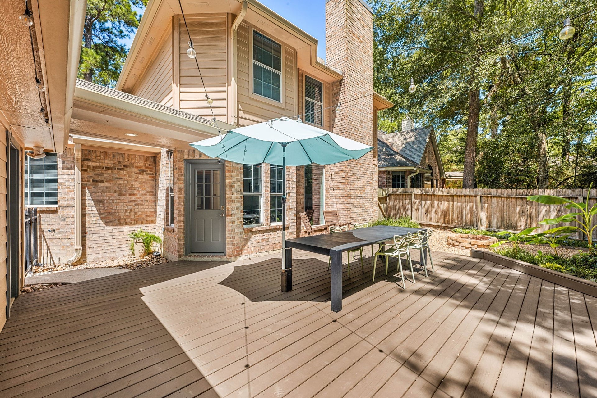 Charming outdoor deck features a spacious seating area. perfect for entertaining. Surrounded by lush greenery and a cozy atmosphere, it offers a seamless blend of comfort and style.