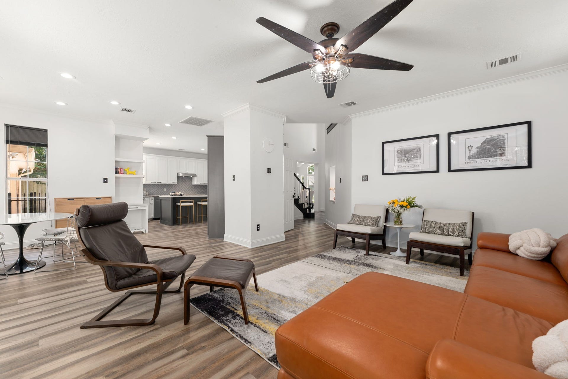 Spacious and inviting living area with modern finishes, featuring an open floor plan that seamlessly connects to a sleek kitchen.