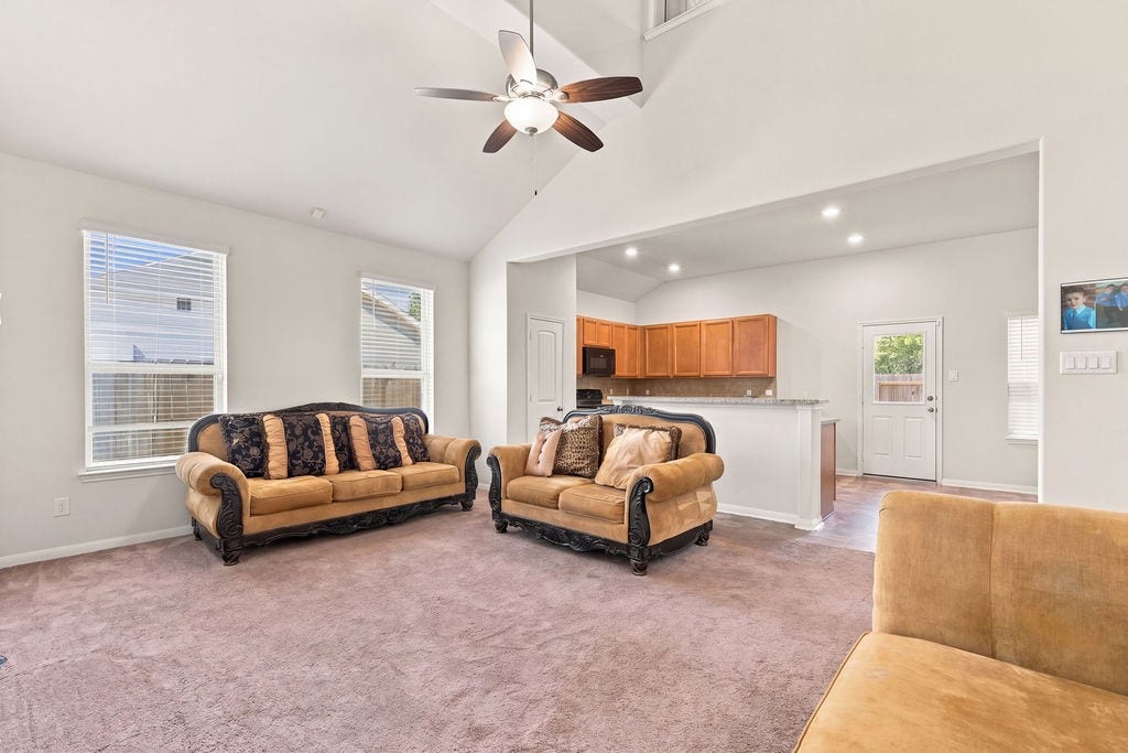 6623 Blimp Base Blvd, Hitchcock, TX 77563 Open airy living area/kitchen and dining room. Room modified.