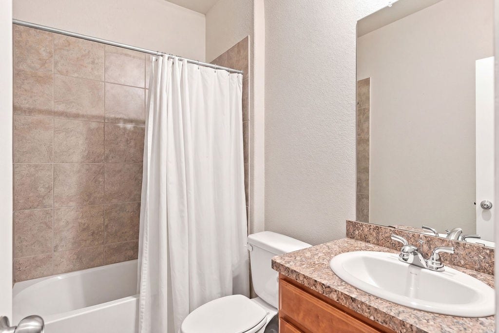 6623 Blimp Base Blvd, Hitchcock, TX 77563 Downstairs full bathroom with tub and shower.