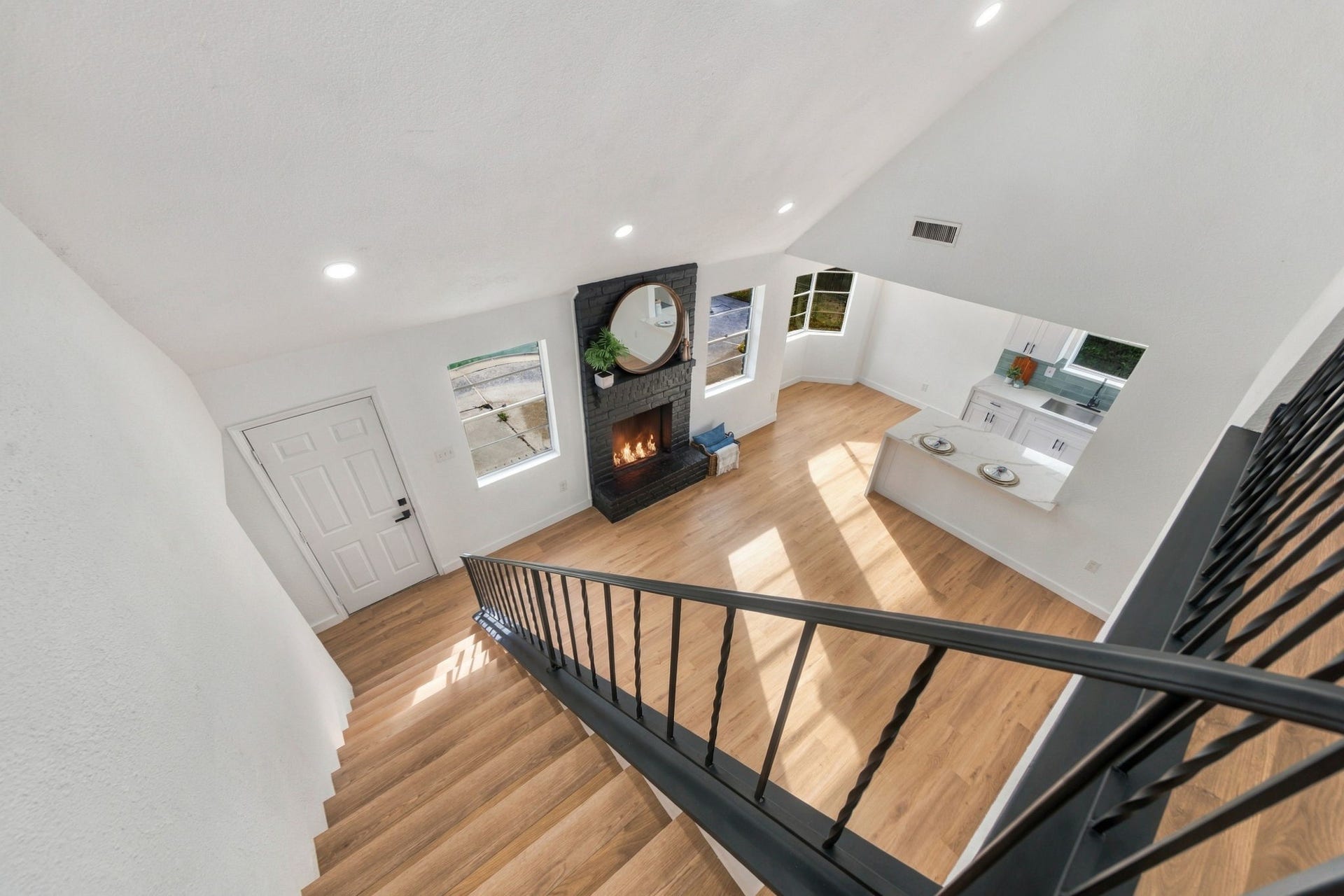 A view overlooking the bright and welcoming living room with seamless flow into the kitchen.