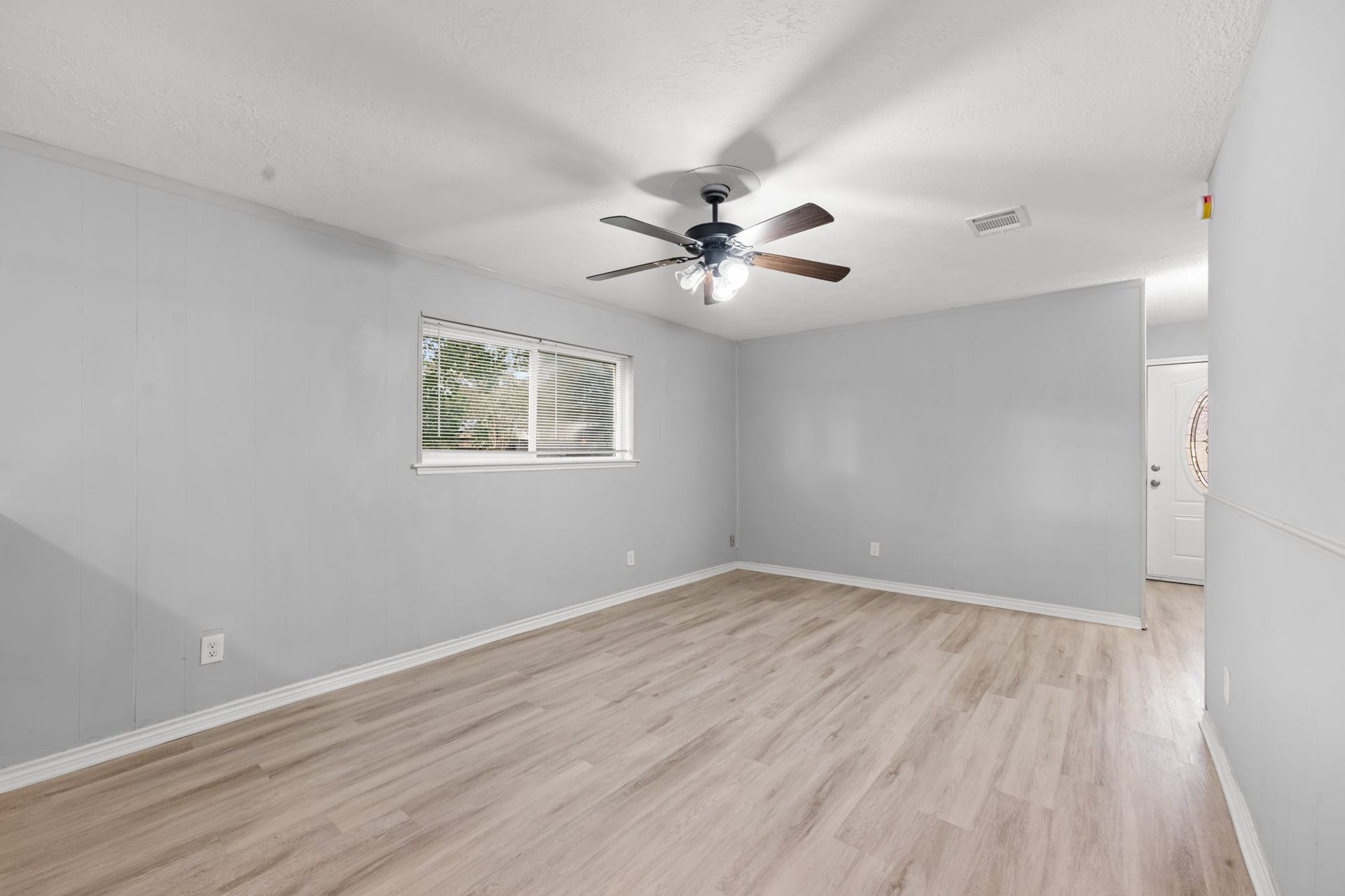 4802 Hannas Reef Drive, Bacliff, TX 77518 Another perspective showcases the living room's comfortable proportions, natural light, and convenient access to the home's front entry.