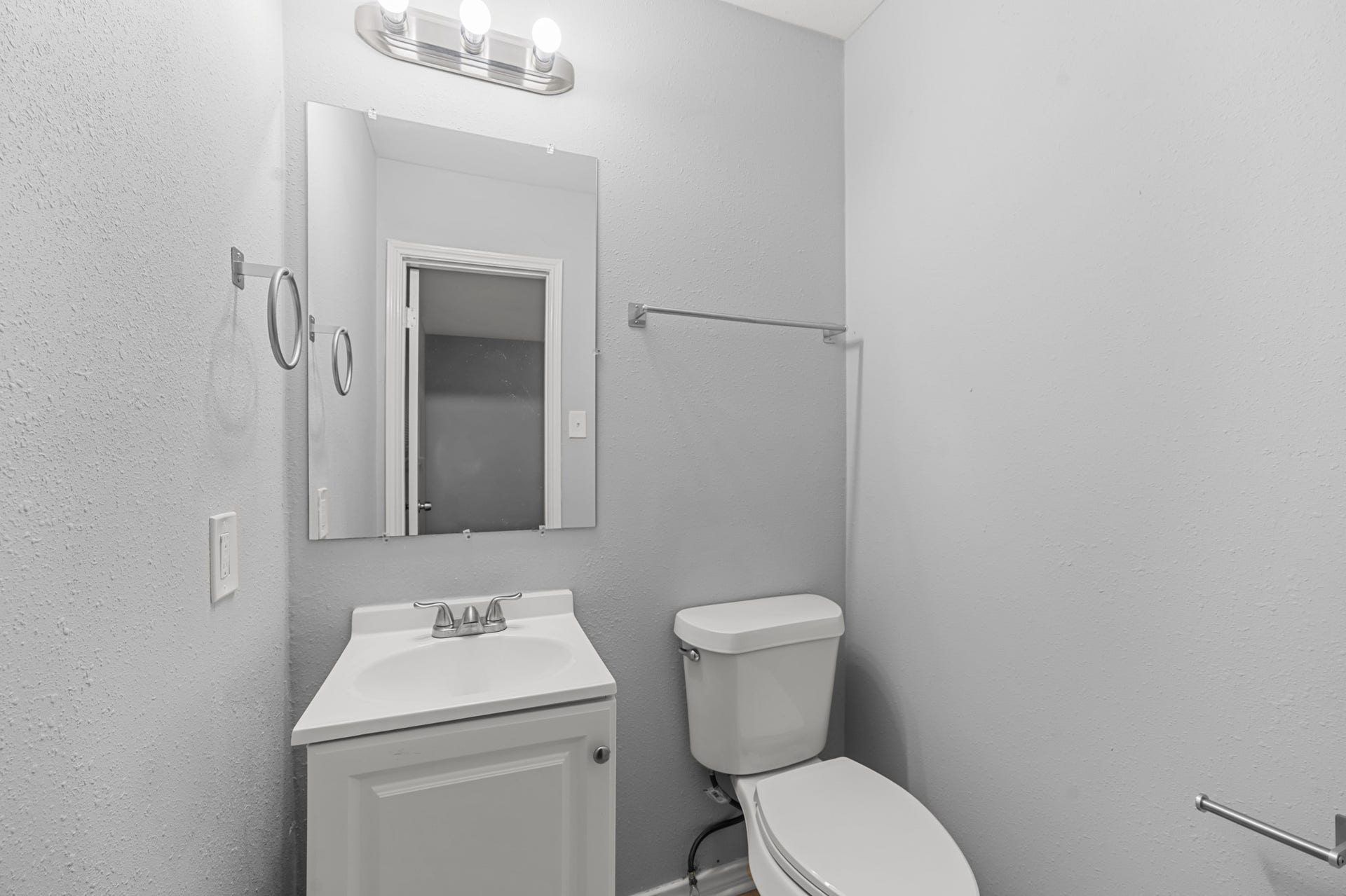 4802 Hannas Reef Drive, Bacliff, TX 77518 Convenient half bath featuring a white vanity, coordinating fixtures, and neutral gray walls, providing an additional bathroom for guests and everyday use.