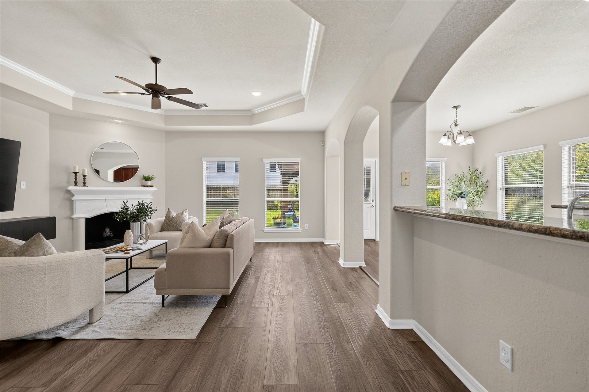1231 Abigail Lane, Friendswood, TX 77546 Your open-concept family room brings everyone together with a cozy fireplace, tray ceiling, and seamless flow into the kitchen and breakfast area.