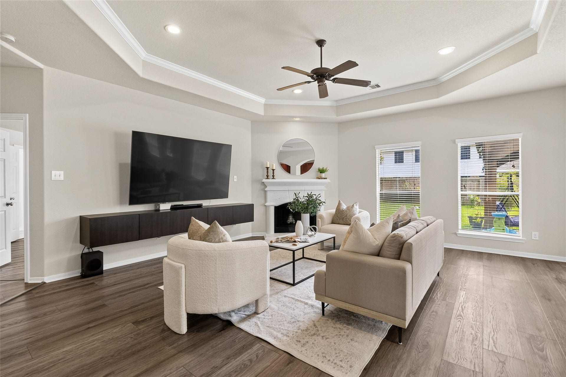 1231 Abigail Lane, Friendswood, TX 77546 Relax by the fireplace or gather for movie nights in the spacious living room, where large windows fill the space with natural light.