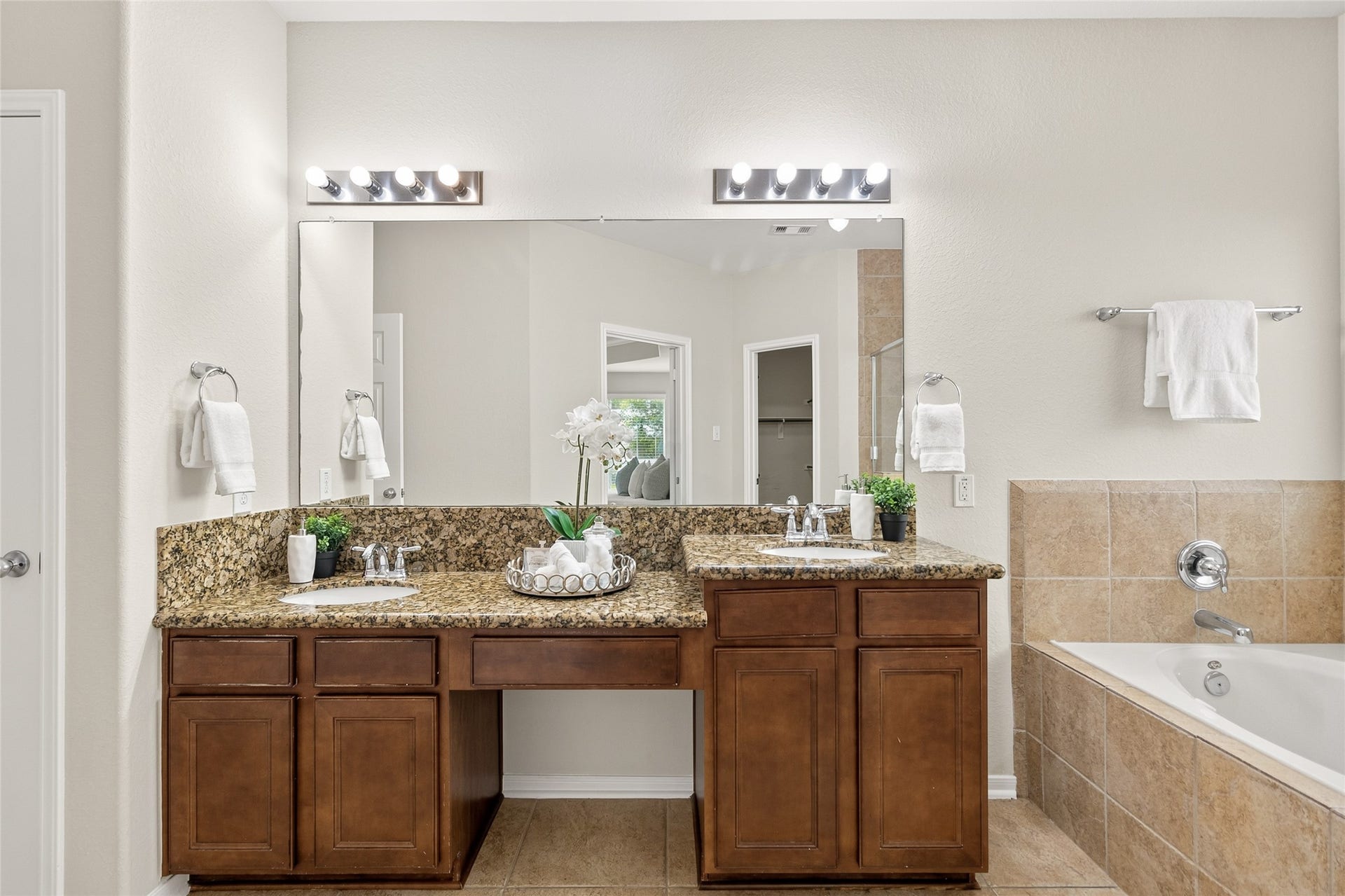 1231 Abigail Lane, Friendswood, TX 77546 Getting ready is effortless with a spacious dual-sink vanity, granite countertops, and plenty of room for your daily routine.