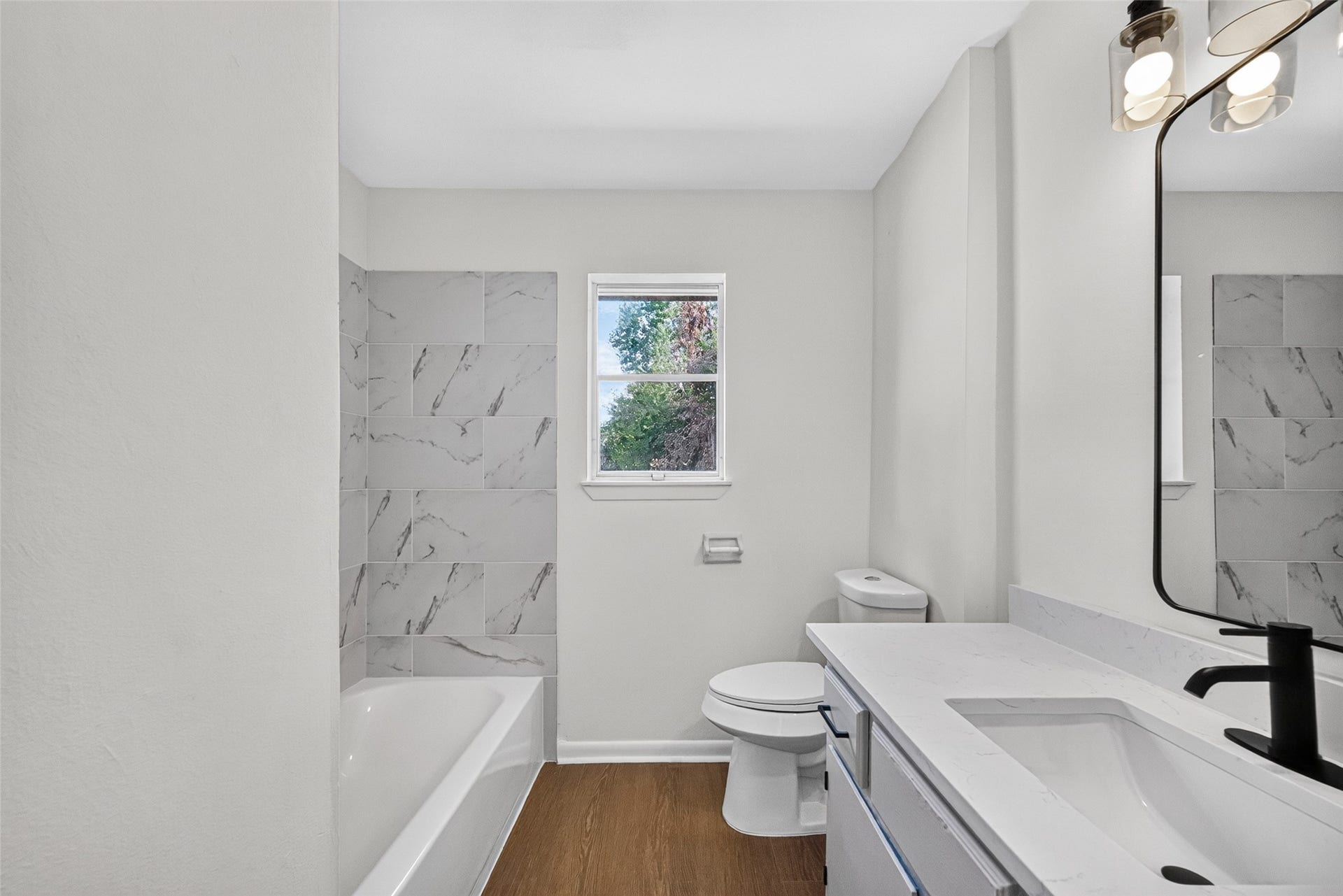 4637 Brinkley Street, Houston, TX 77051 Updated primary bathroom featuring a shower and tub combination.