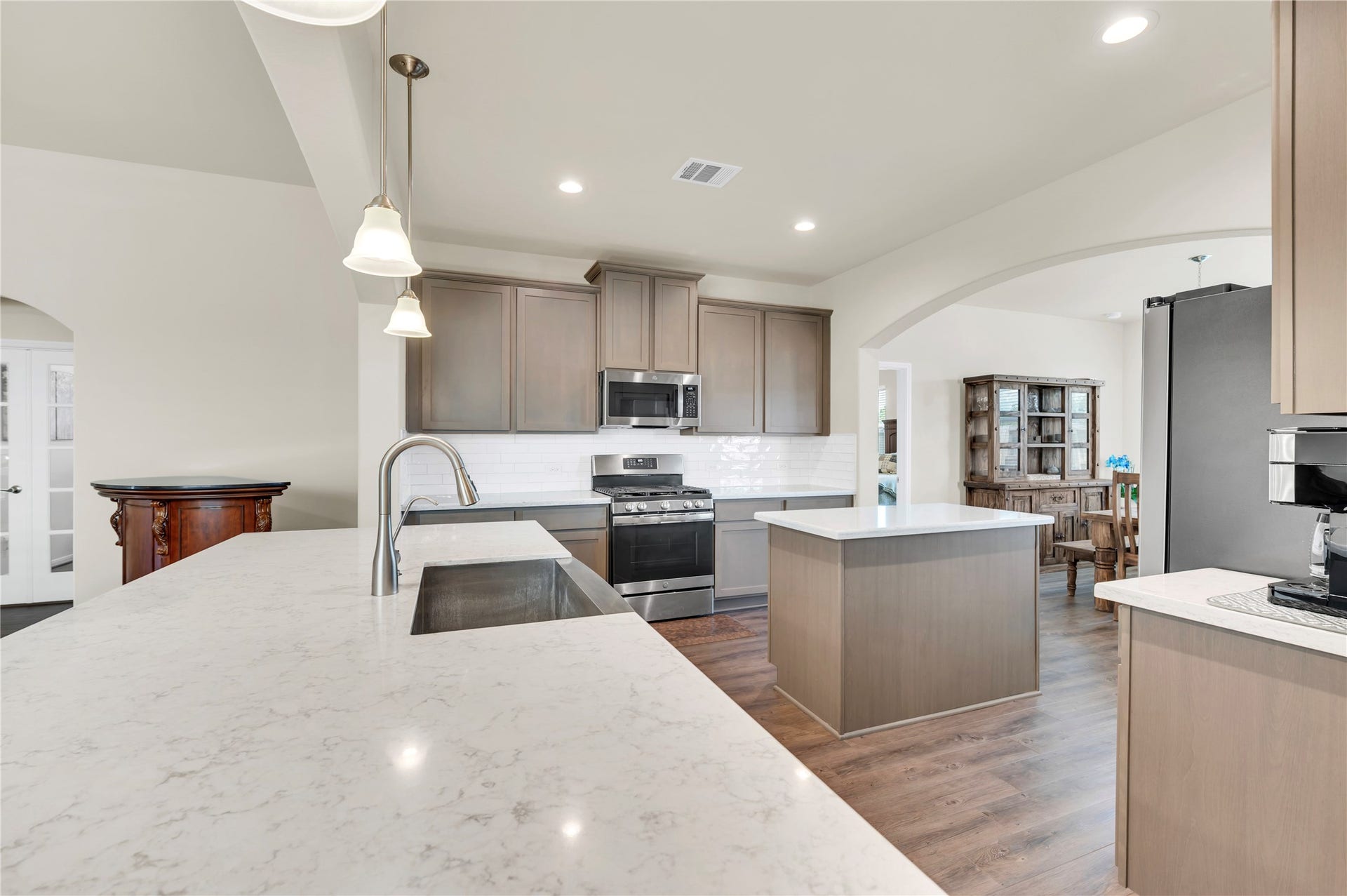 1849 Kenley Way, Alvin, TX 77511 This modern kitchen also features a second island for food prep and meal set up. as well as an abundance of cabinets for plenty of storage.
