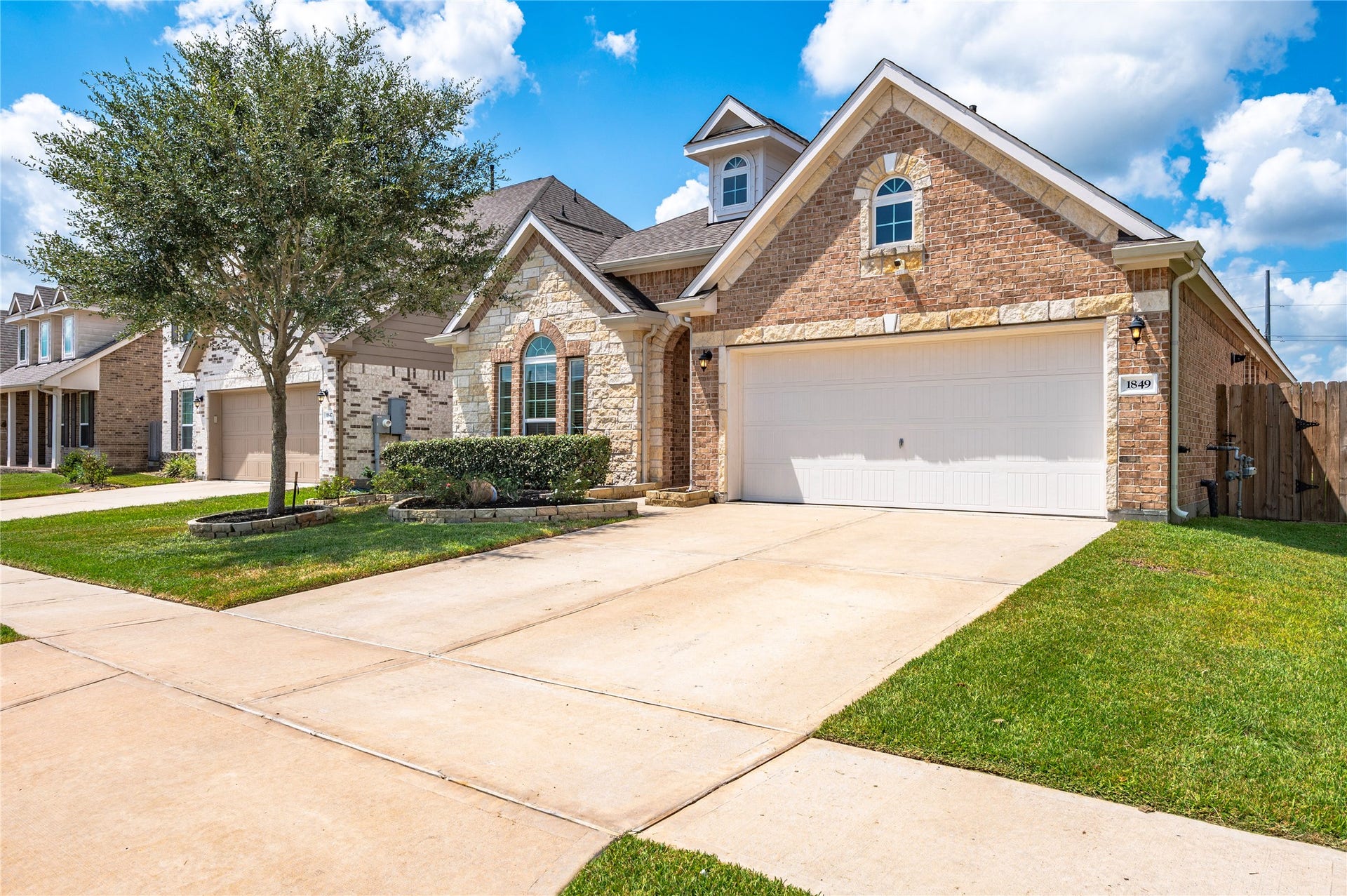 1849 Kenley Way, Alvin, TX 77511 Charming brick and stone exterior with a spacious two-car garage, nestled in a well-maintained neighborhood. No MUD Taxes and a low HOA make this home a very affordable option.