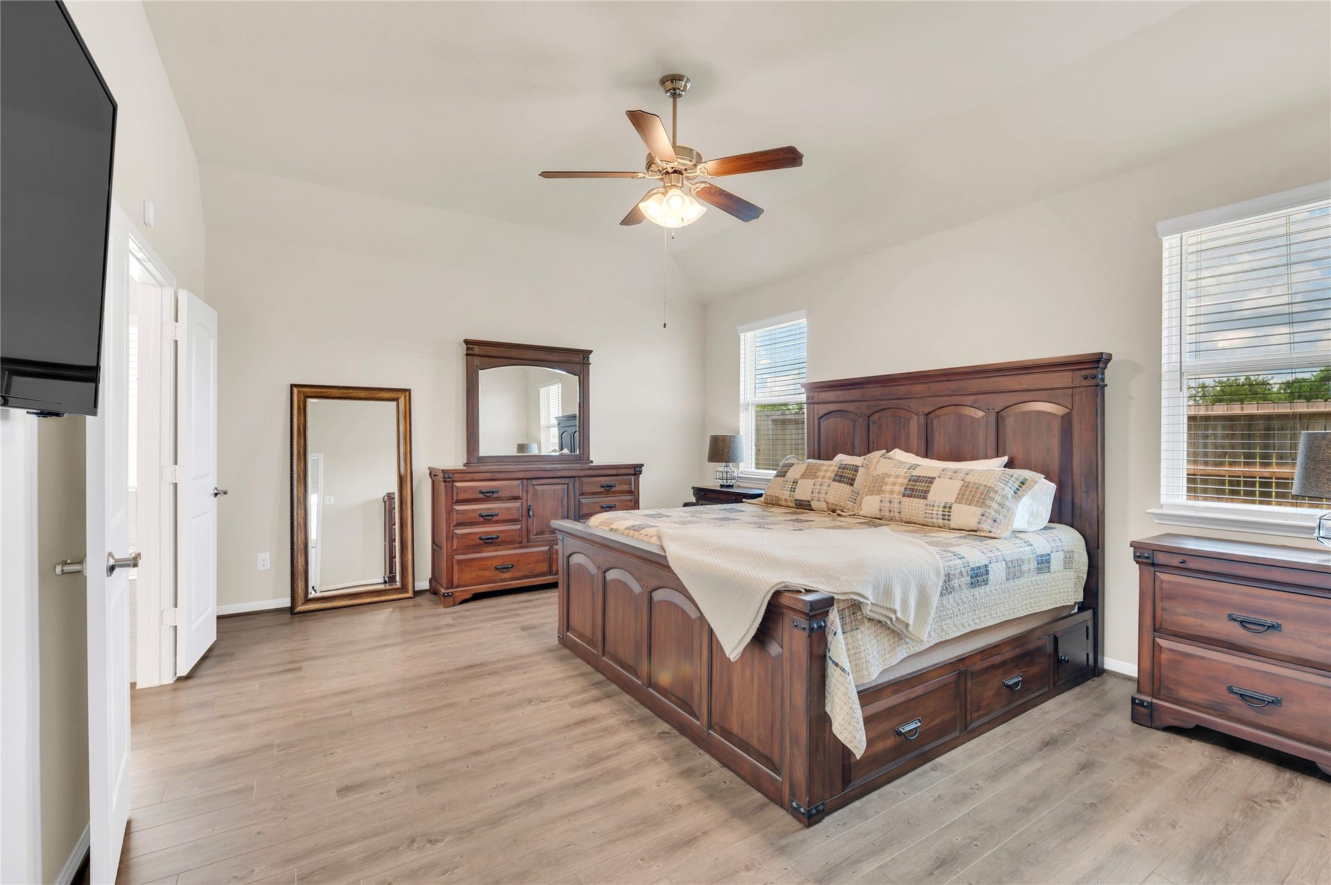 1849 Kenley Way, Alvin, TX 77511 Spacious bedroom featuring elegant upgraded flooring, a ceiling fan, and ample natural light.