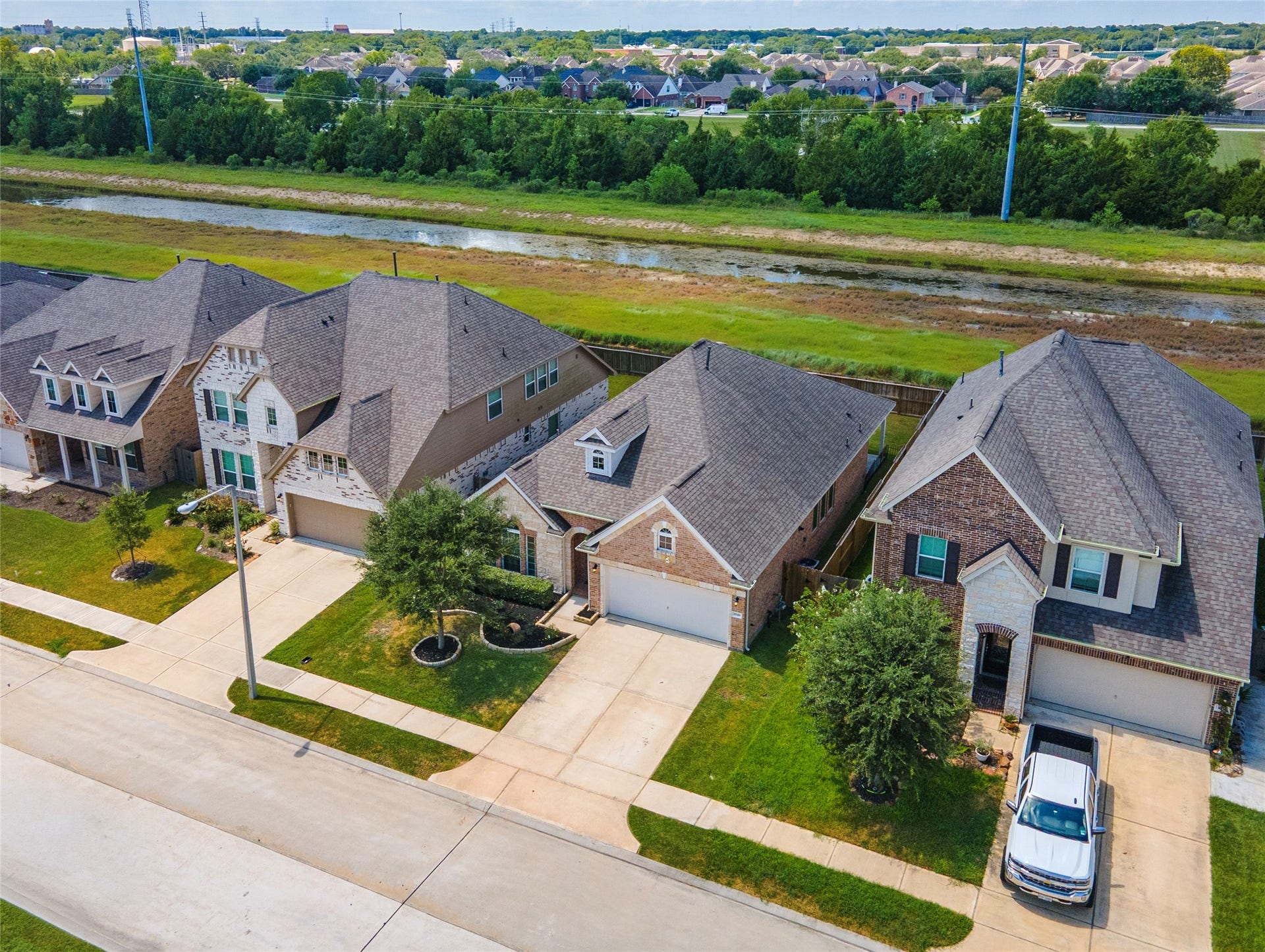 1849 Kenley Way, Alvin, TX 77511 Charming neighborhood with well-maintained homes, spacious driveways, and lush greenery. Enjoy the serene backdrop of a greenbelt for no back neighbors, offering privacy and a touch of nature.