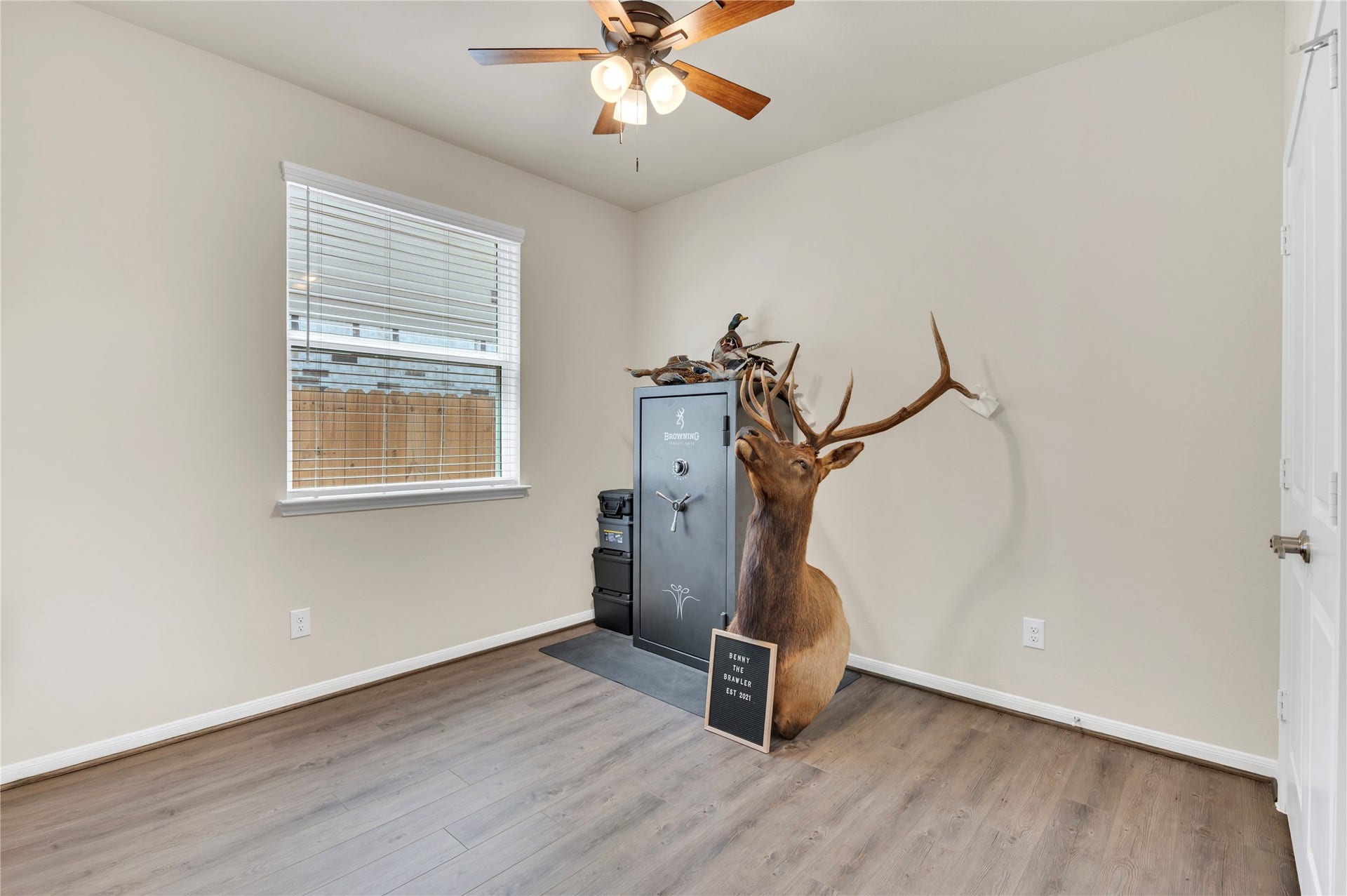 1849 Kenley Way, Alvin, TX 77511 A versatile 3rd bedroom with wood flooring, neutral walls, and a ceiling fan, perfect for use as a study or hobby space.