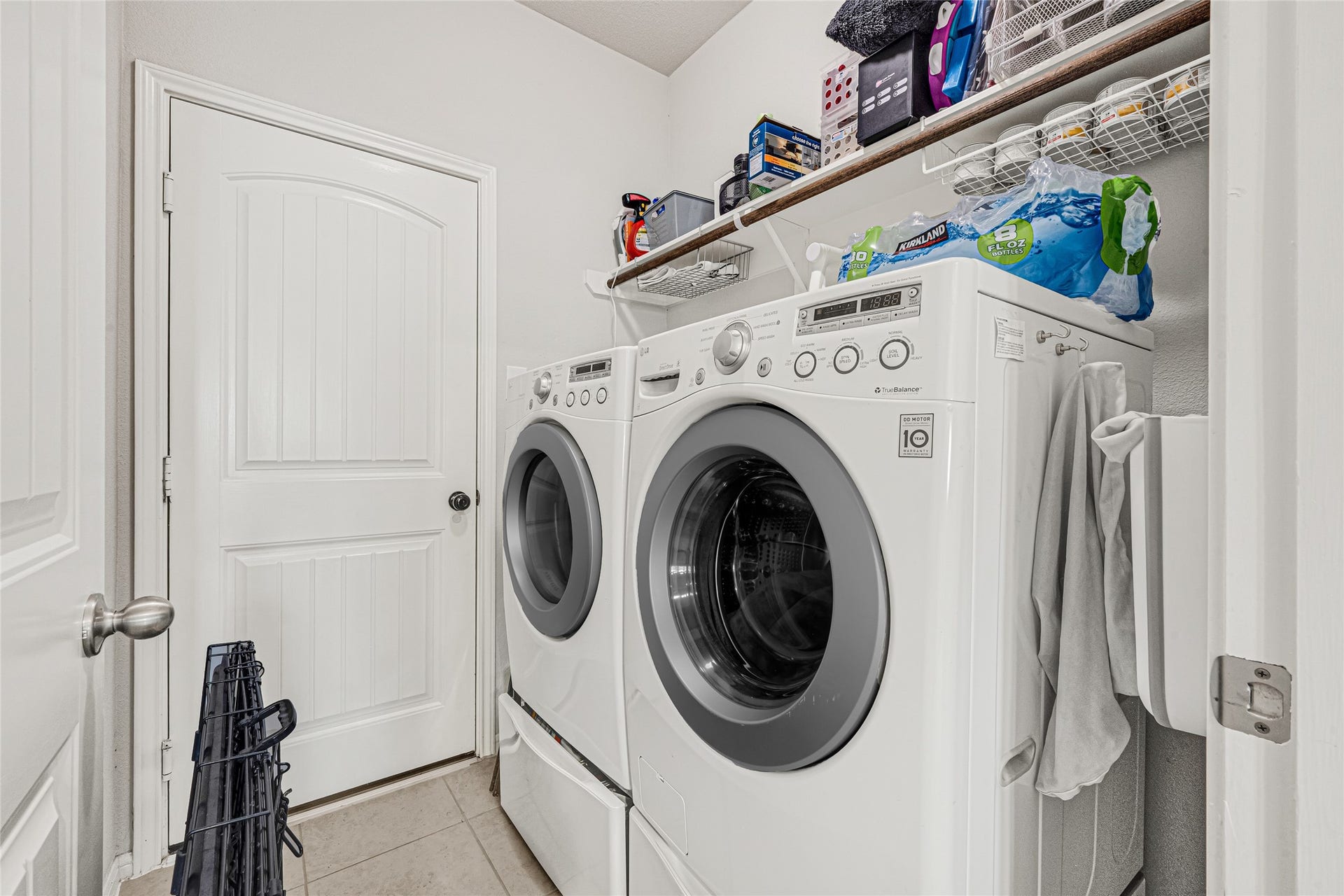 5318 Abbeville Court, Dickinson, TX 77539 Convenient indoor utility room with additional shelving for storage.