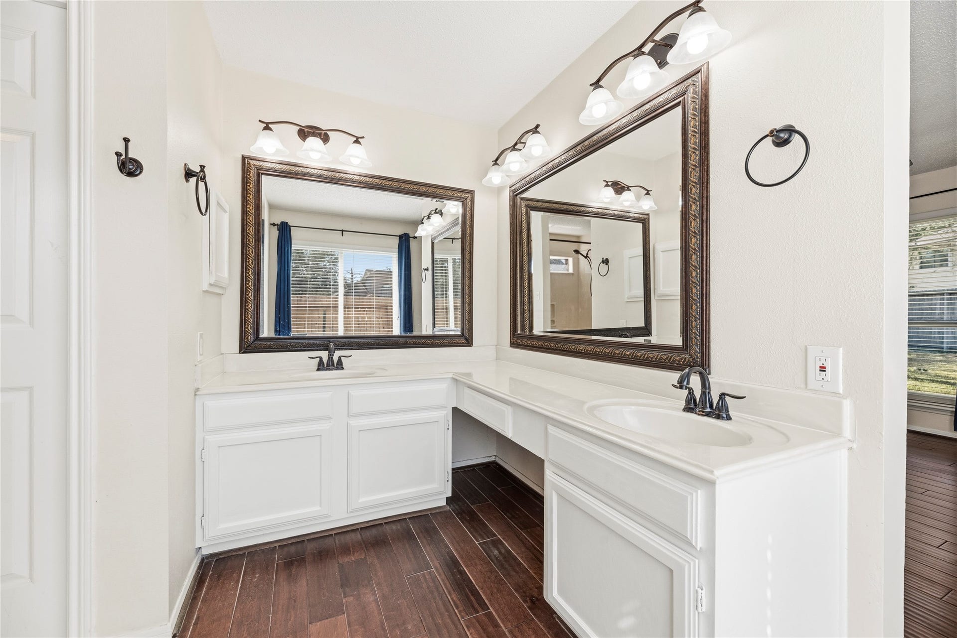 Dual sink vanity and framed mirrors in the primary bathroom.