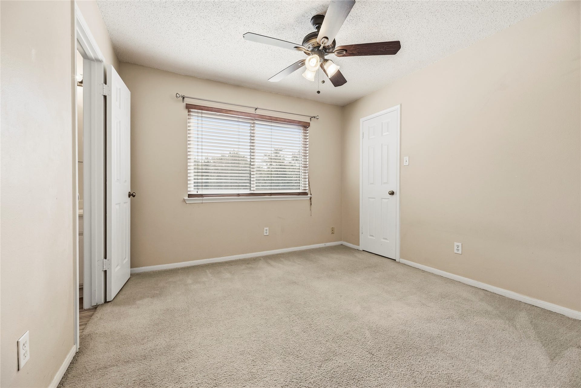 Both upstairs secondary bedrooms offer carpeted flooring, ceiling fans and ample closet space.