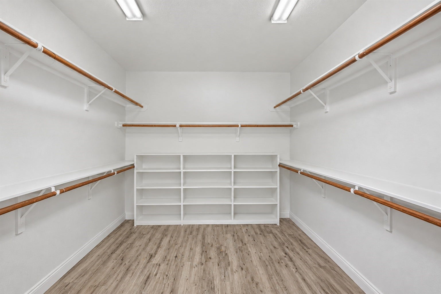 Oversized primary closet offering abundant hanging space, shelving, and storage.