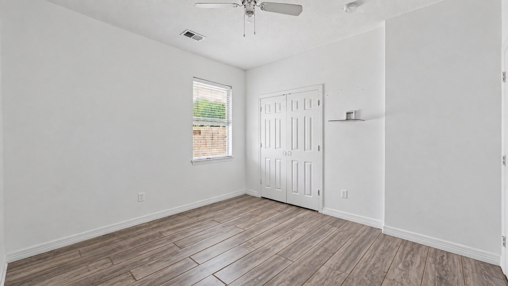 Another view of the secondary bedroom featuring a ceiling fan, closet and durable tile flooring. ***Digitally enhanced guest BR images - floors need to be finished