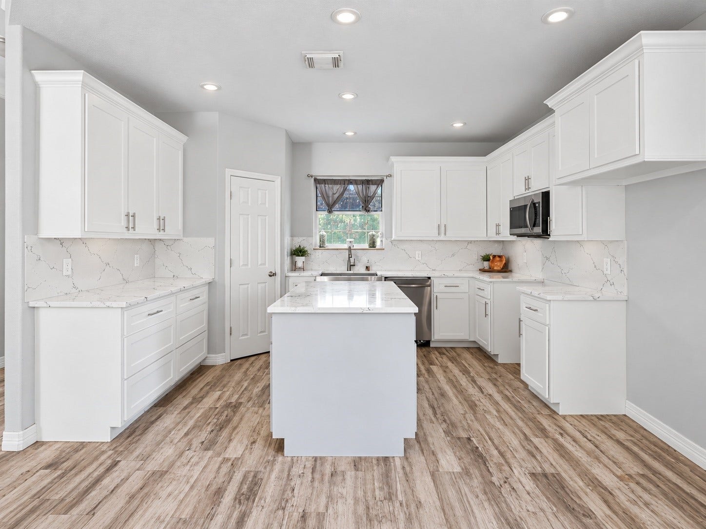 Spacious kitchen with abundant cabinet and counter space, stainless steel appliances, and a functional center island. ***Digitally enhanced kitchen pictures - backsplash needs to be completed