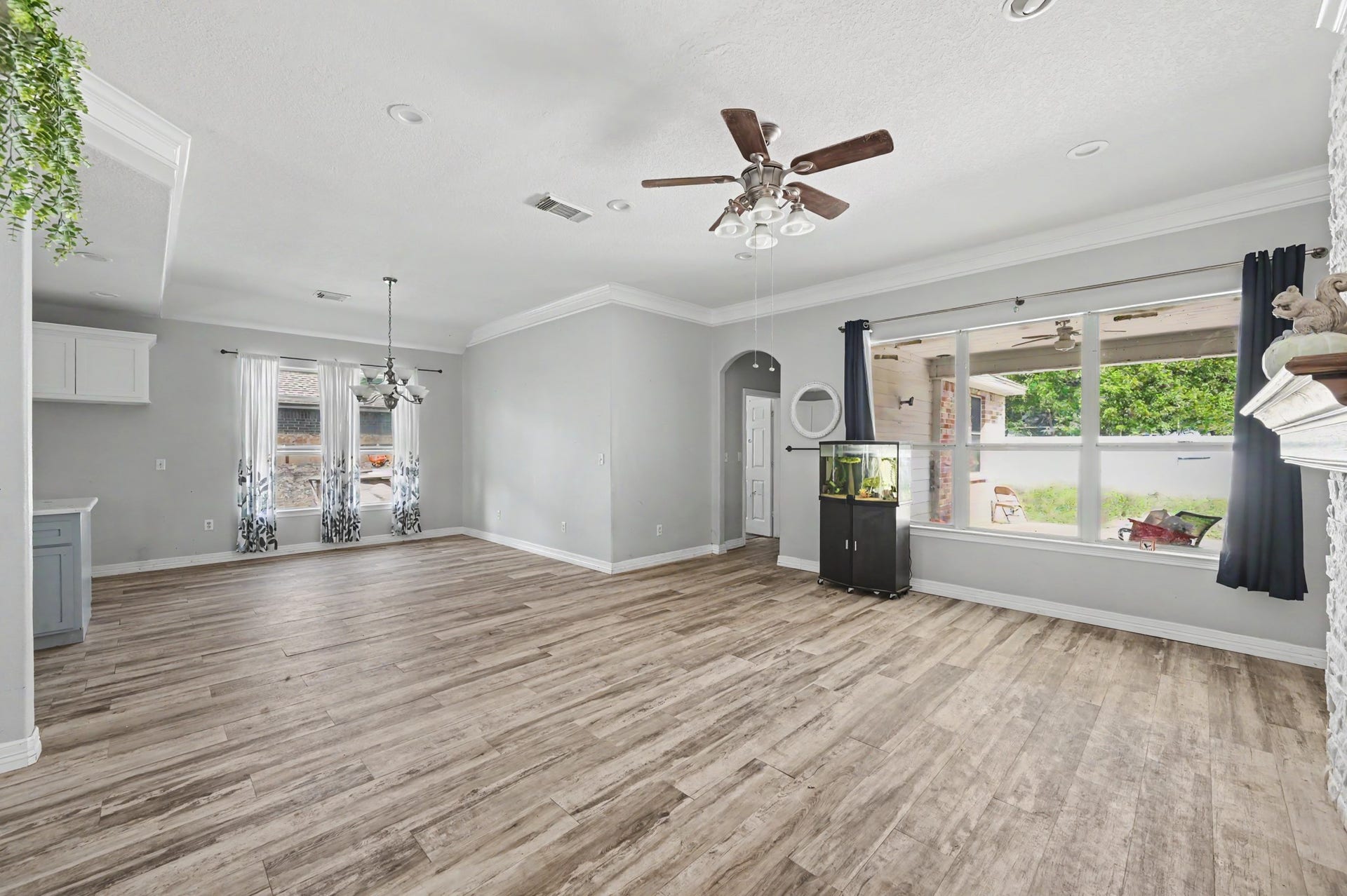 Bright, open concept living space with windows, high ceilings, and plenty of room for multiple seating arrangements.