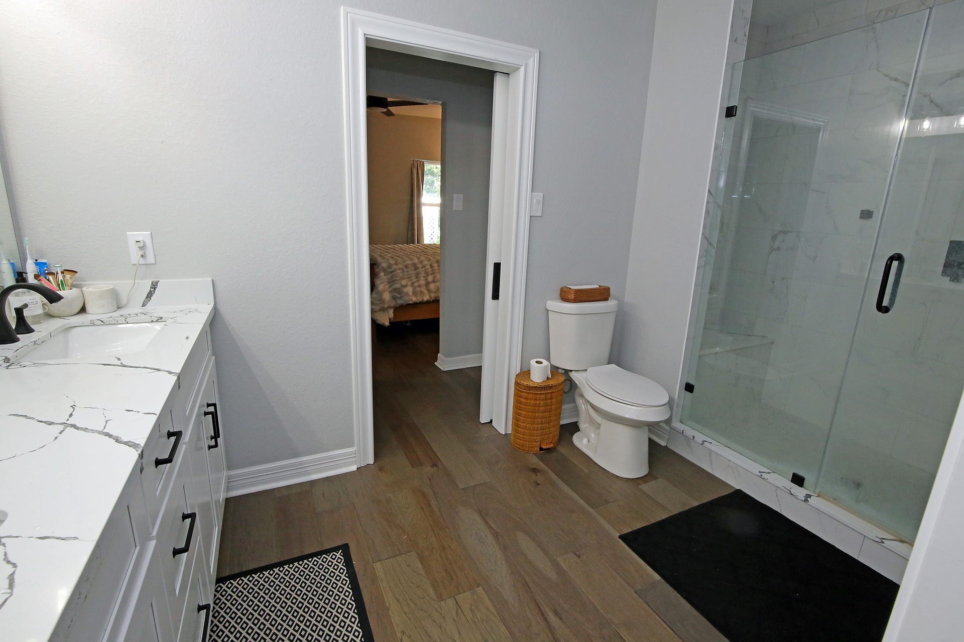 7101 2nd Street, Hitchcock, TX 77563 Bathroom with oversized shower and wood flooring and quartz countertops