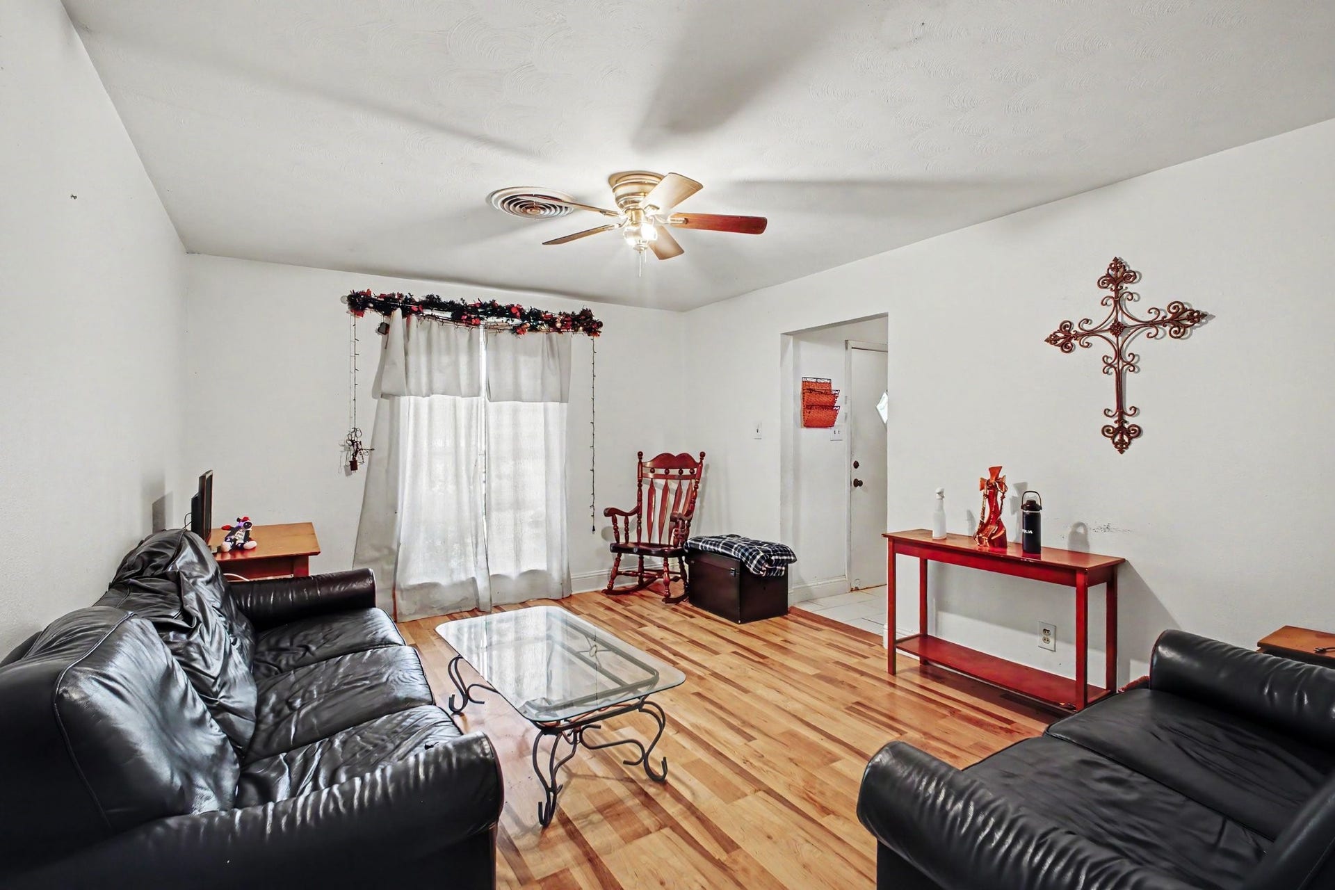Cozy living room view looking toward the front interior, featuring stylish hardwood flooring.