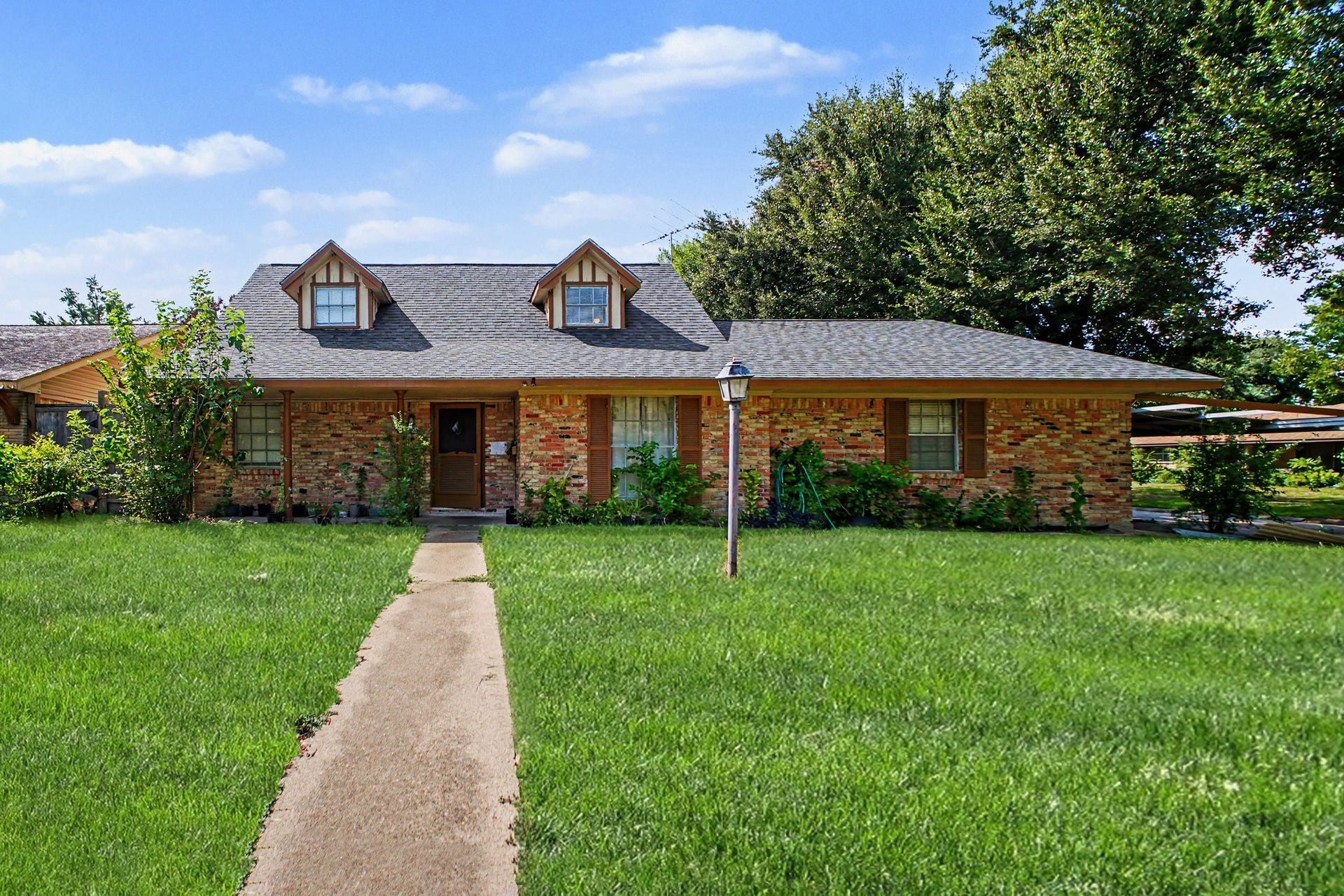 Detailed approach view showcasing the front architecture and welcoming curb appeal.