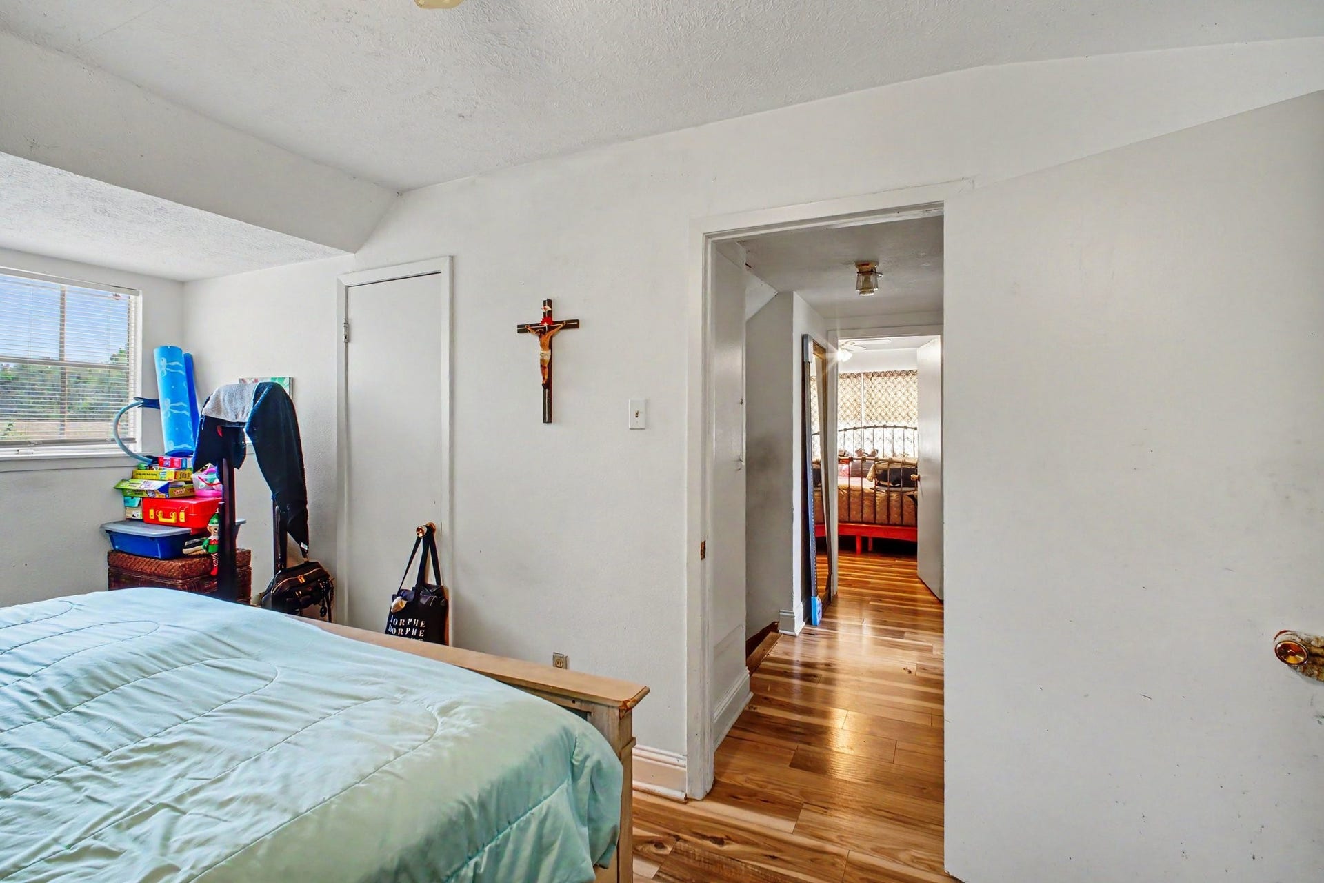Bright central hallway looking through to interior rooms with clean white trim and doors.