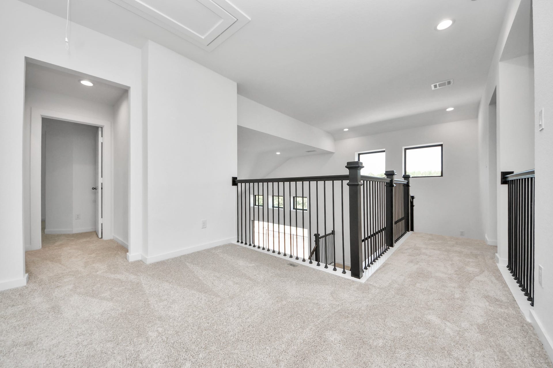 Ascend to relaxation in this fantastic game room! Ideal for both casual gatherings and adult gaming, it boasts plush carpet, lofty ceilings, custom paint, and ample windows for abundant natural light.