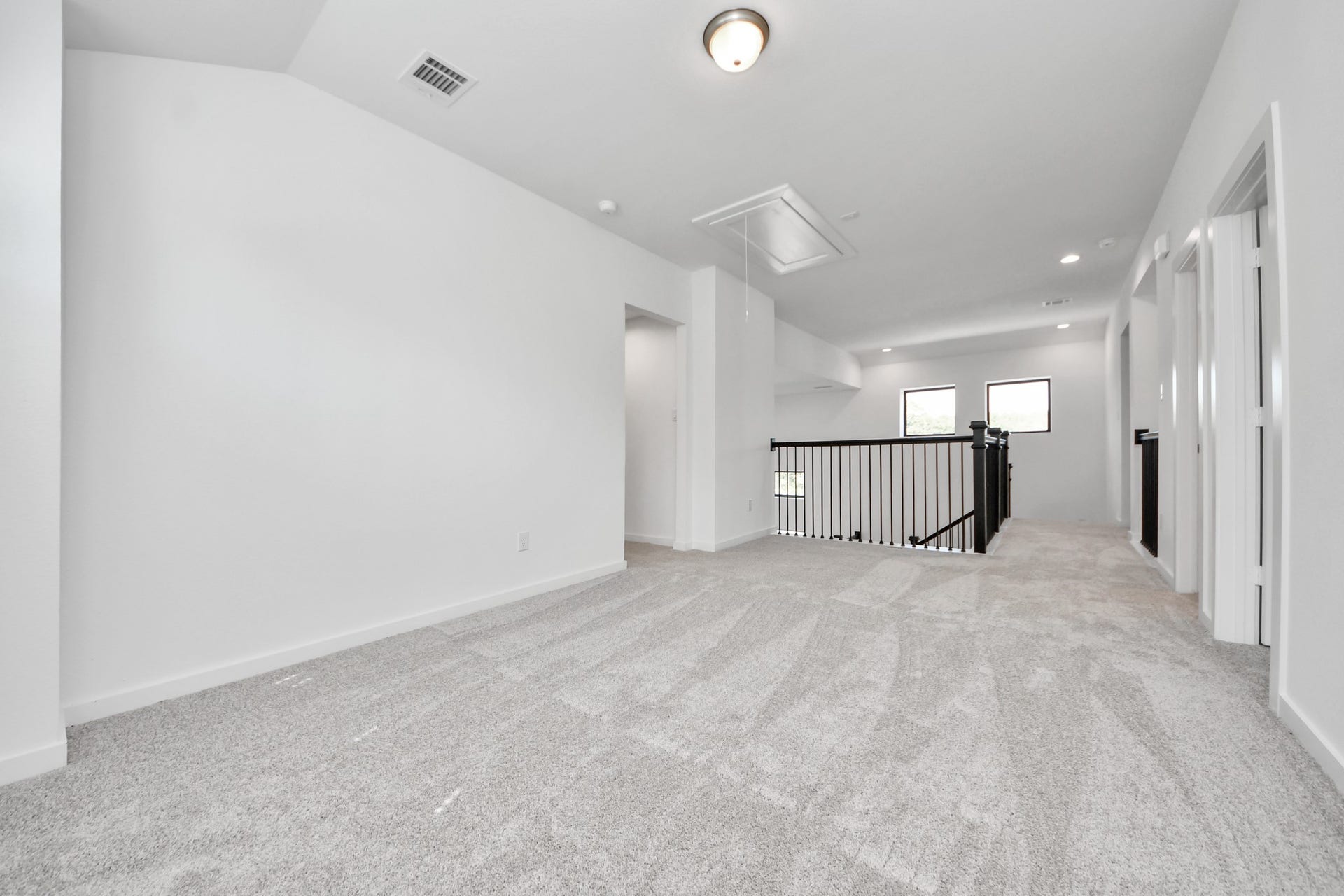 Come upstairs and enjoy a day of leisure in this fabulous game room! This is the perfect hangout spot or adult game room! Features plush carpet, high ceilings, custom paint and windows for plenty of natural light.