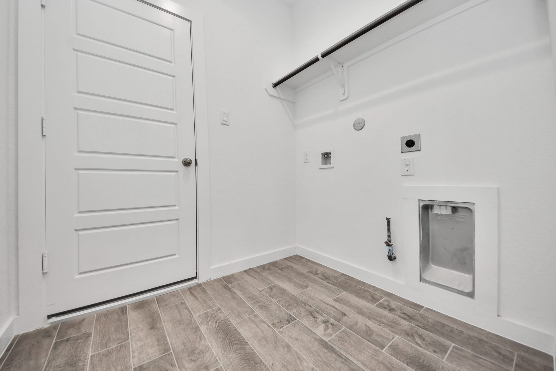 A perfect blend of functionality and comfort. Capture the essence of easy living with a first-floor laundry room, thoughtfully equipped with shelving for effortless organization. Both electric and gas connections available.