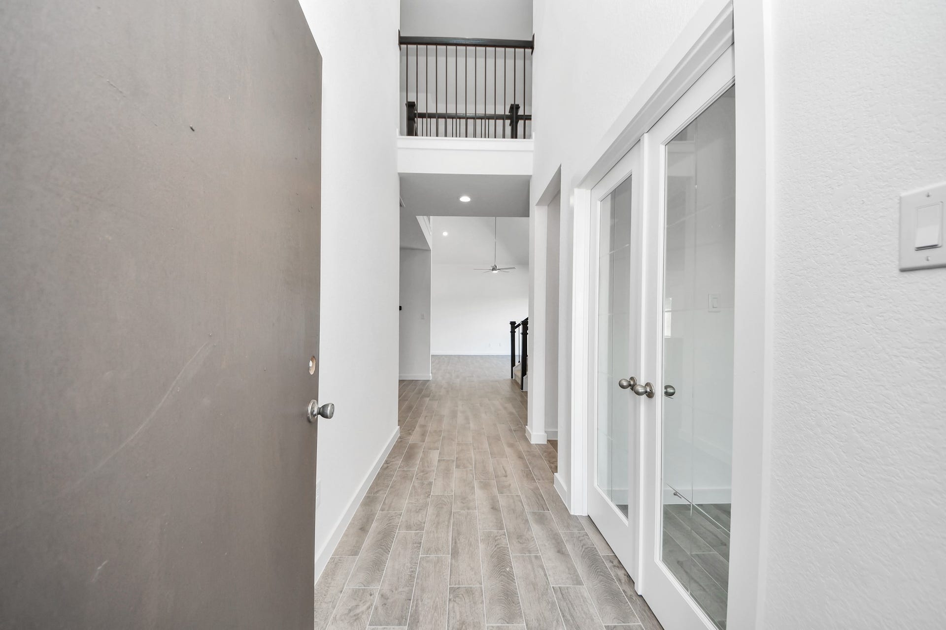 As you step into the threshold of this luxurious home, you'll soon be welcomed by an elegant glass door (to be installed). Inside, soaring ceilings amplify the spaciousness, while the refined wood-look tile flooring and oversized baseboards exude sophistication and charm.
