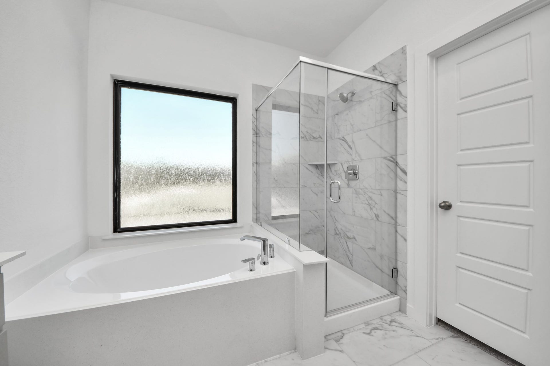 Indulge in a spa-like retreat within the confines of this primary bathroom. Delight in a spacious walk-in shower enveloped in stylish tile surround, unwind in a separate garden tub adorned with custom detailing.