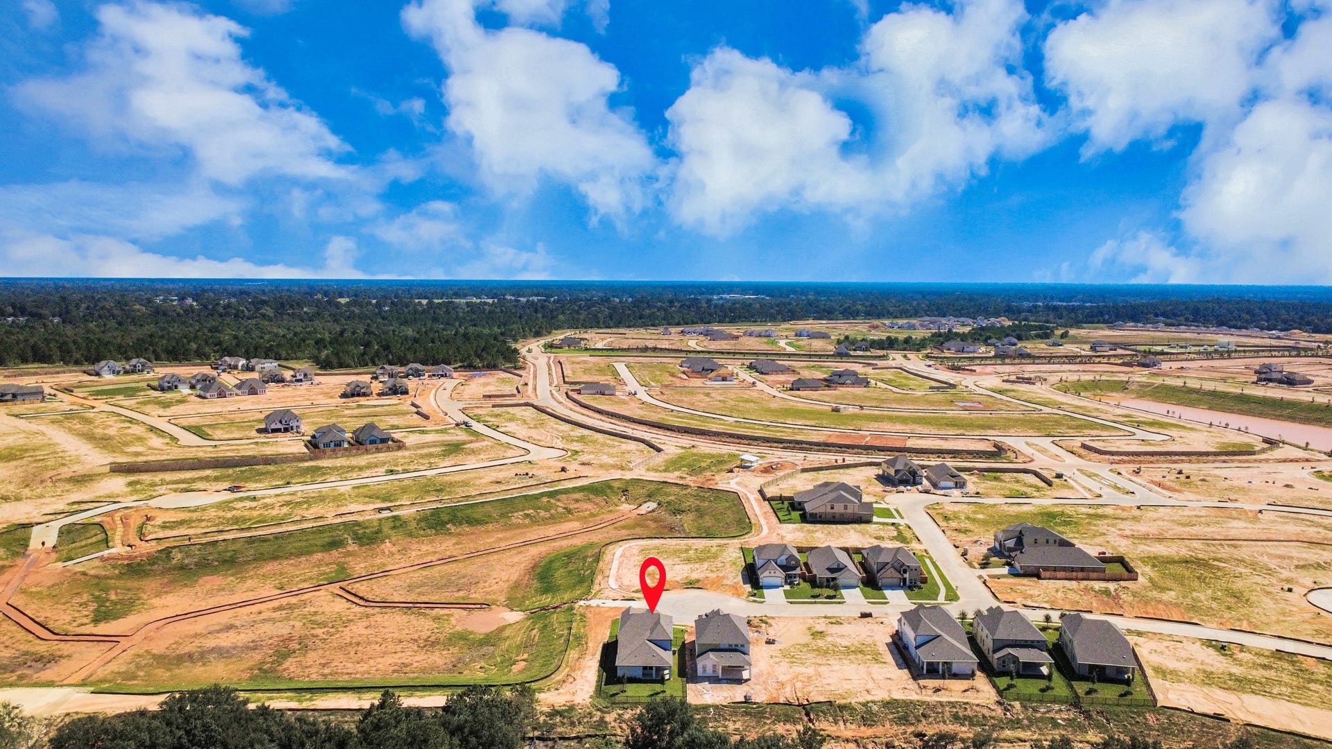 An aerial view of a spacious subdivision lot, highlighting a well-maintained yard and a fully fenced perimeter, offering both privacy and expansive outdoor space.