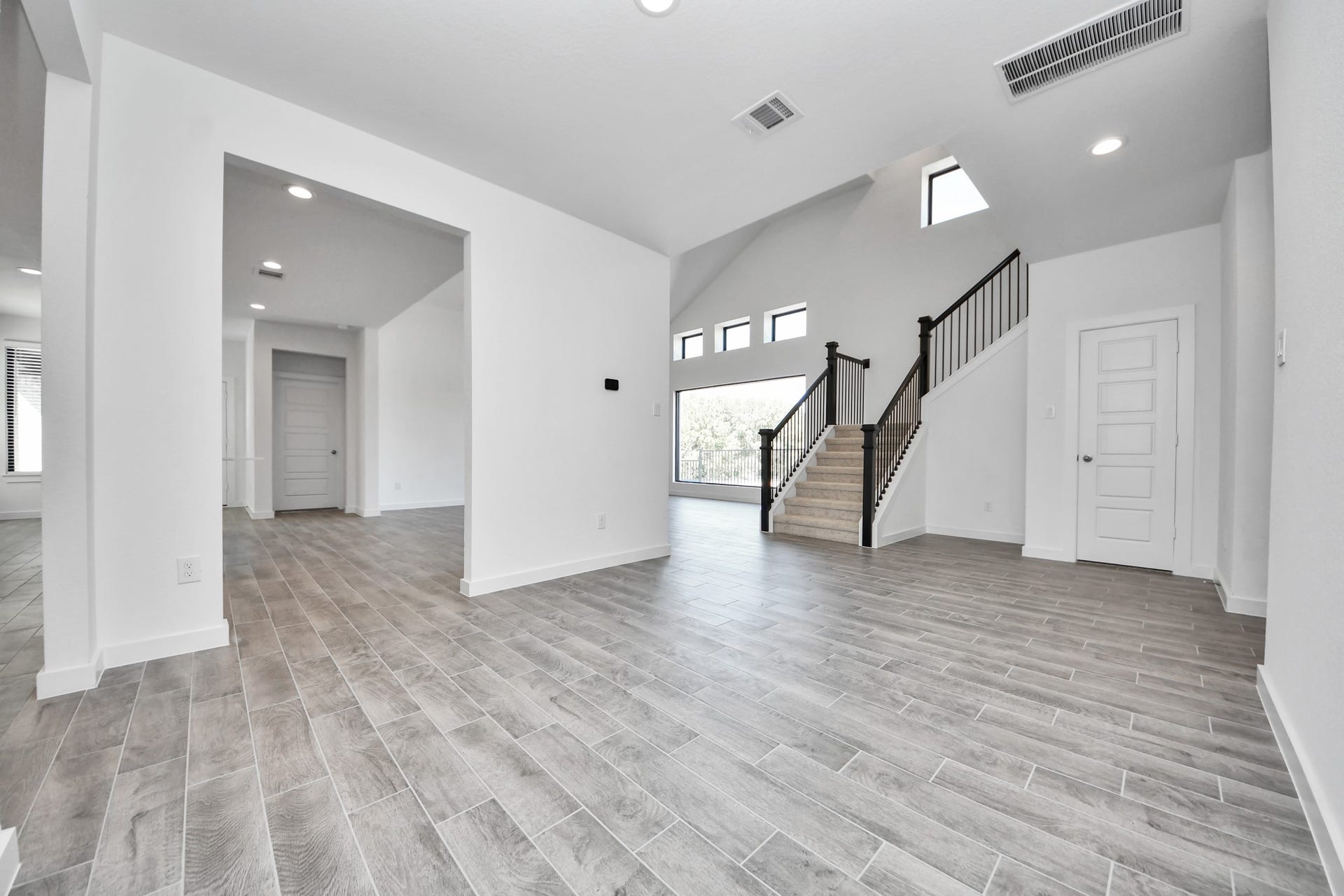 Create lasting memories with your family and friends at the dining table! This expansive dining room showcases sophisticated flooring, custom paint, and seamlessly connects to the family room and kitchen, providing an open and inviting atmosphere