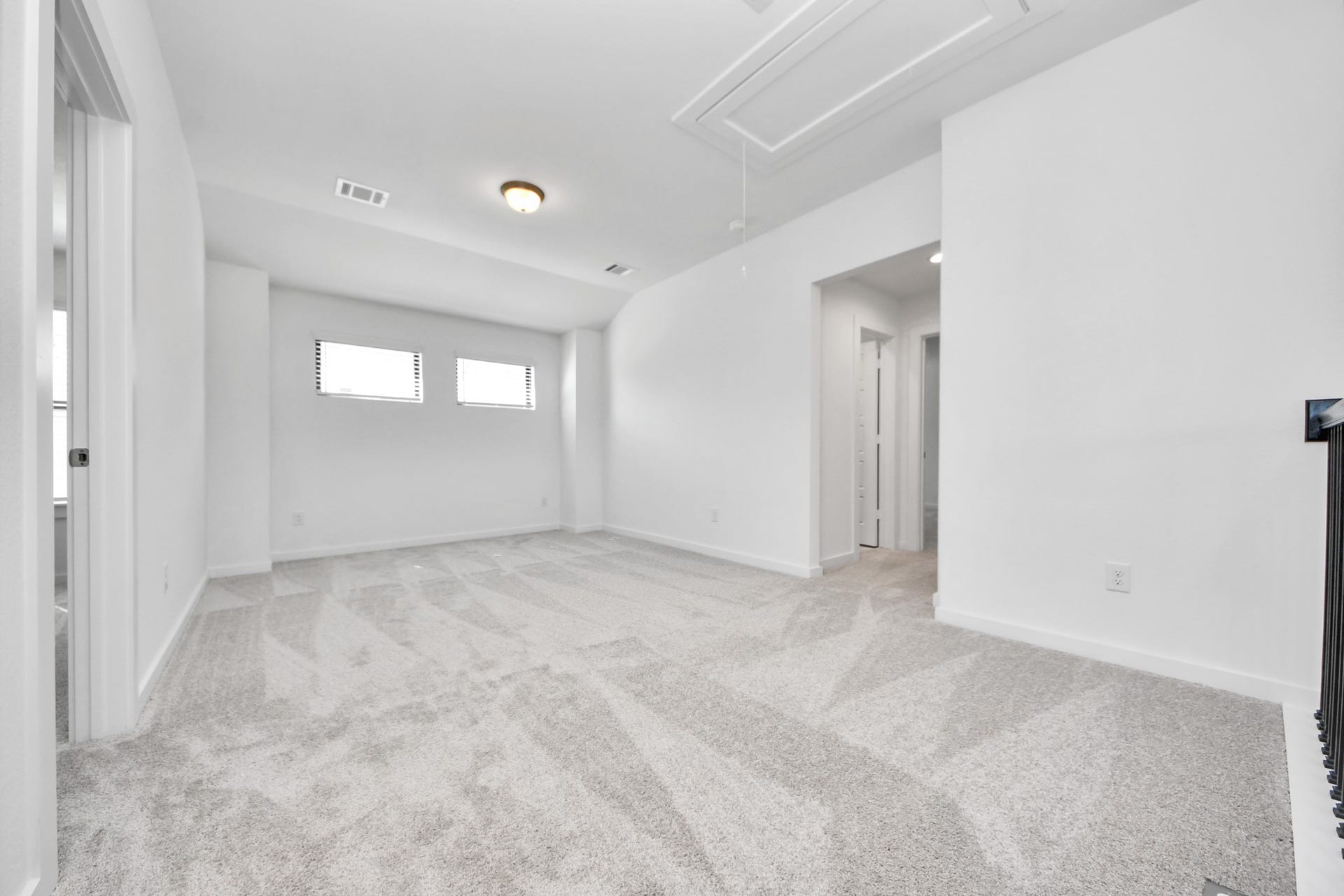 Ascend to relaxation in this fantastic game room! Ideal for both casual gatherings and adult gaming, it boasts plush carpet, lofty ceilings, custom paint, and ample windows for abundant natural light.