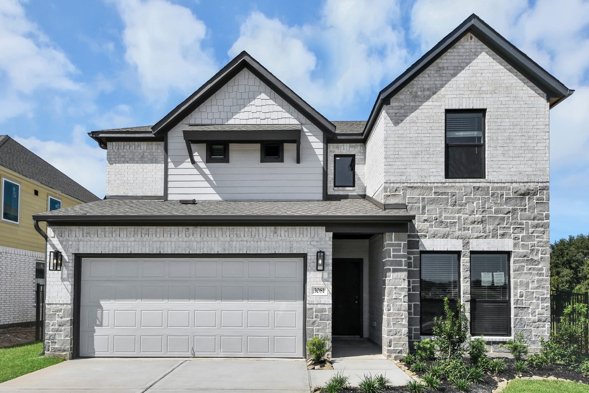 The residence features a practical 2-car garage complemented by a generous driveway, ensuring abundant space for parking needs.