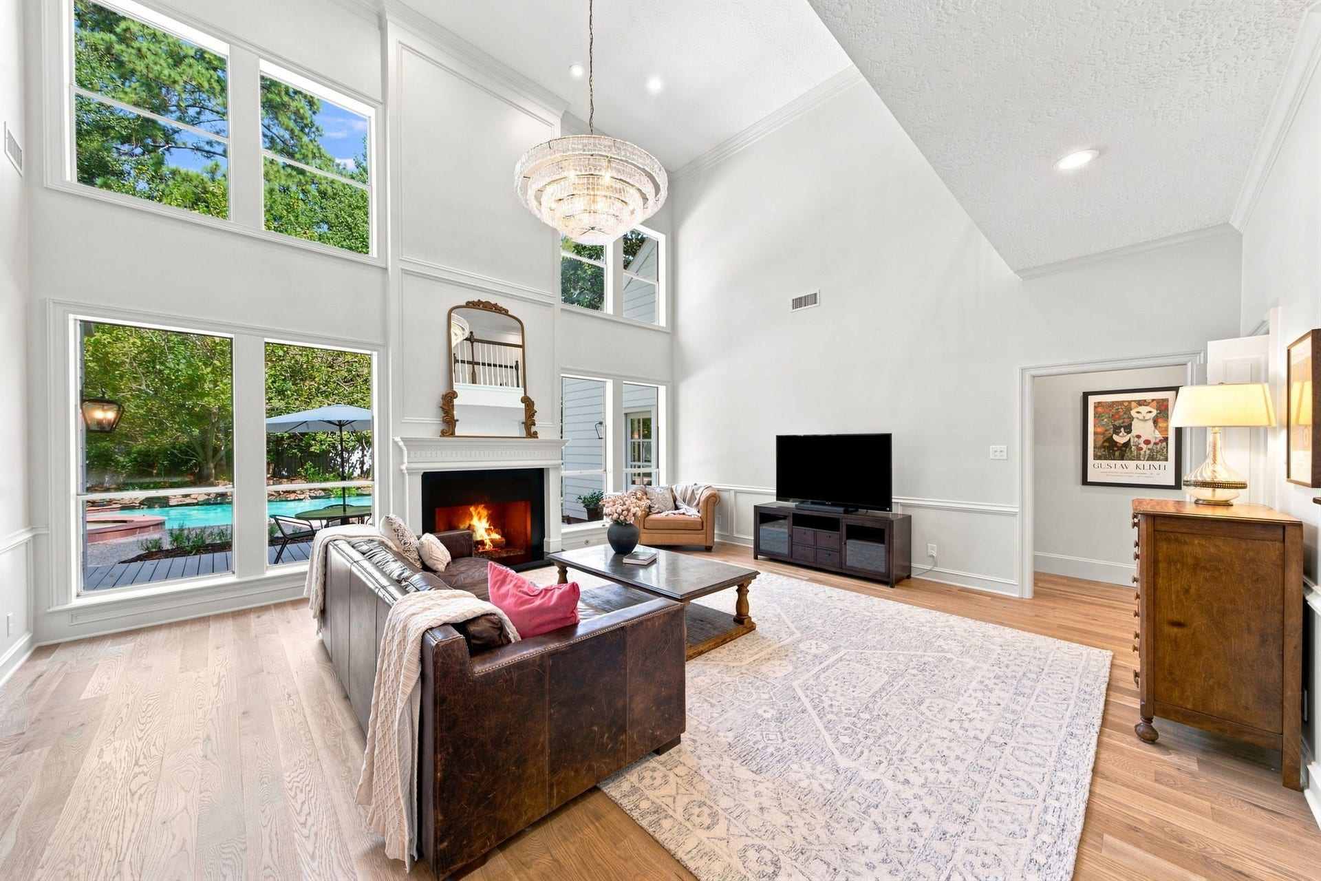 23 S Brokenfern Drive Drive, The Woodlands, TX 77380 This great room highlights a beautiful soapstone gas fireplace and a stunning premium signature chandelier