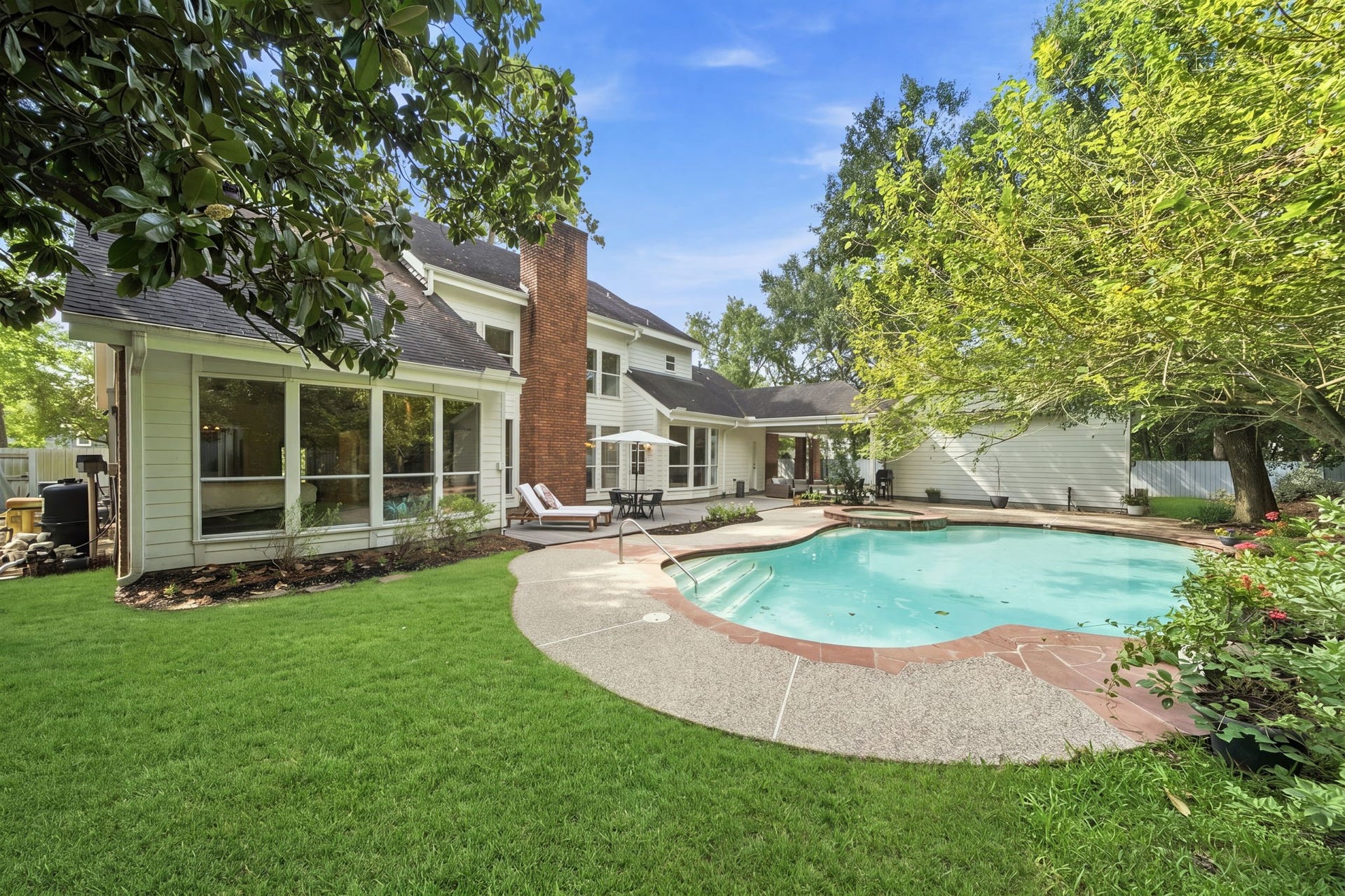 23 S Brokenfern Drive Drive, The Woodlands, TX 77380 Spacious backyard perfect for outdoor activities and entertaining
