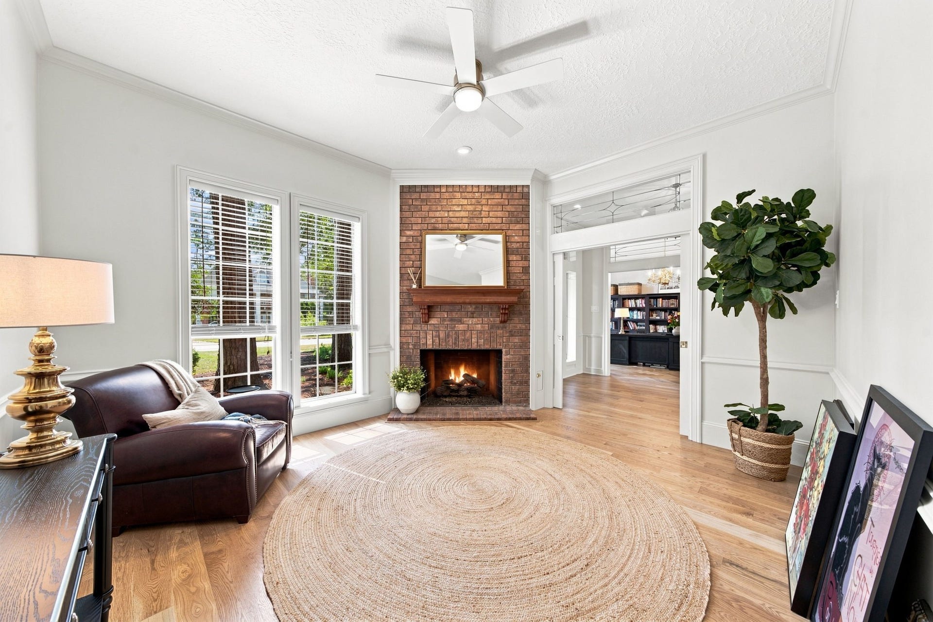 23 S Brokenfern Drive Drive, The Woodlands, TX 77380 Bright, airy home office featuring a cozy gas fireplace and abundant natural light.