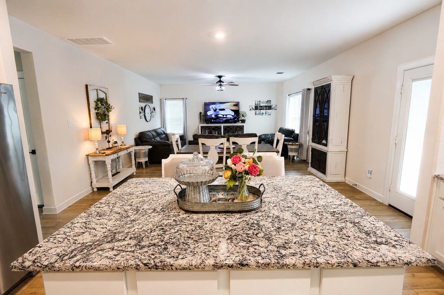 837 Dawn Redwood Court, Conroe, TX 77304 Spacious open-concept living area featuring a stylish granite kitchen island, cozy seating, and abundant natural light, perfect for entertaining and relaxation.