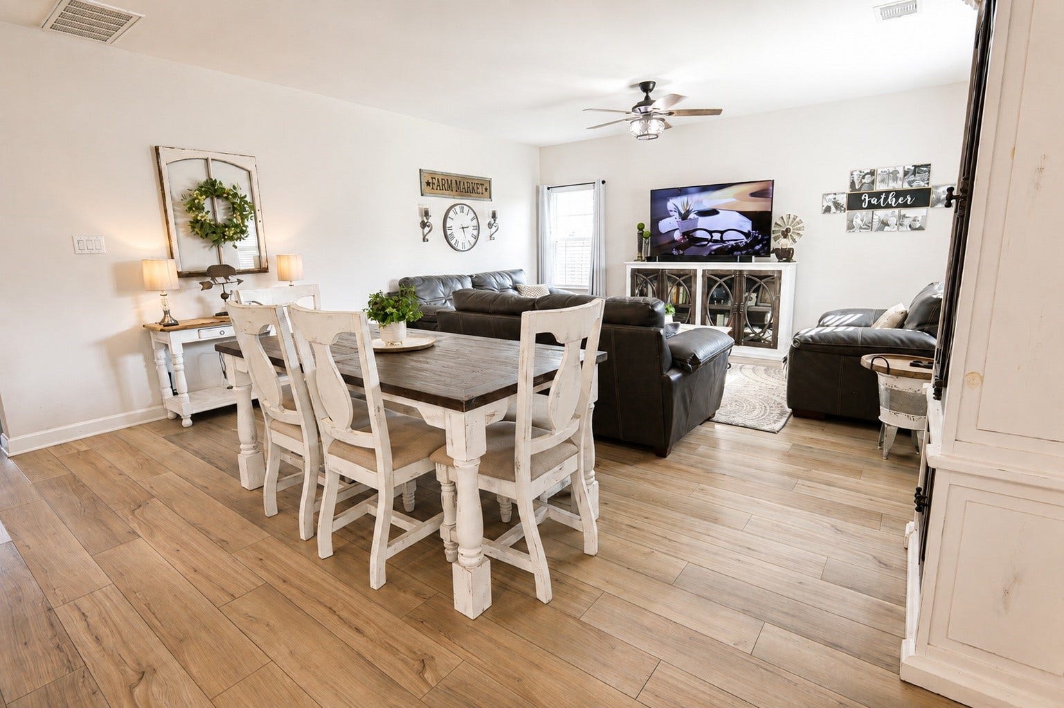 837 Dawn Redwood Court, Conroe, TX 77304 Charming open-concept living and dining area features elegant laminate flooring.